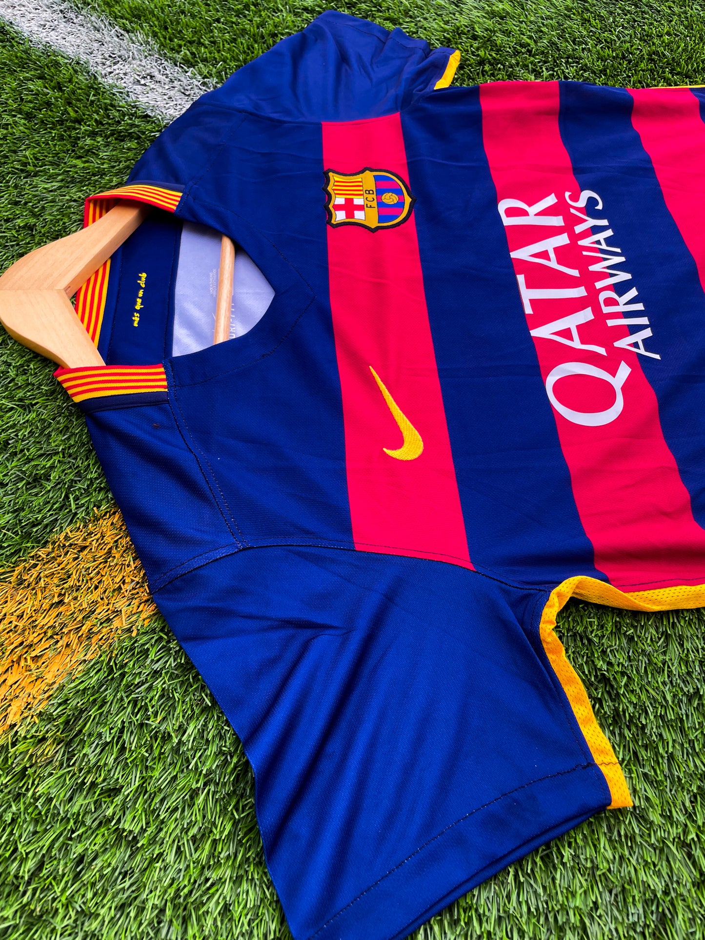 Close-up of Nike logo and Barça crest on red-blue stripes