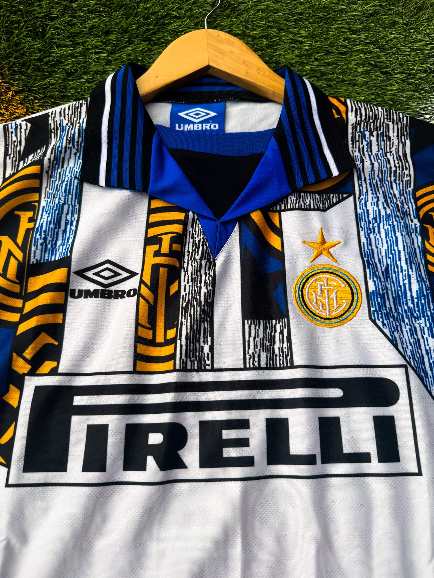 Close-up of embroidered Inter crest, Umbro logo, and Pirelli sponsor