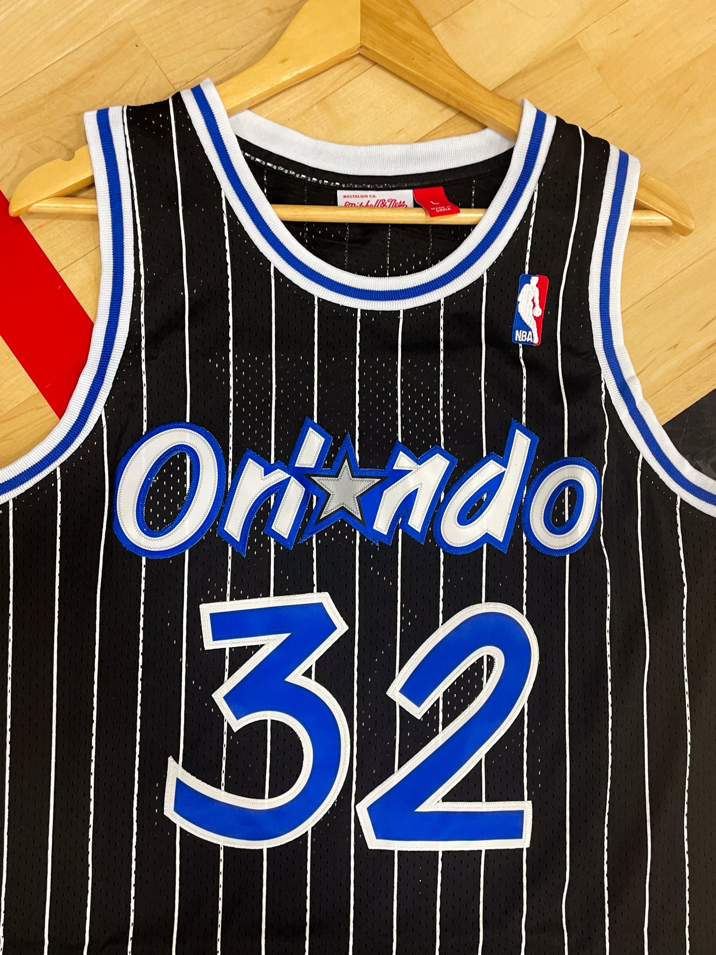 Close-up of the pinstripe design and team logo on the Magic jersey