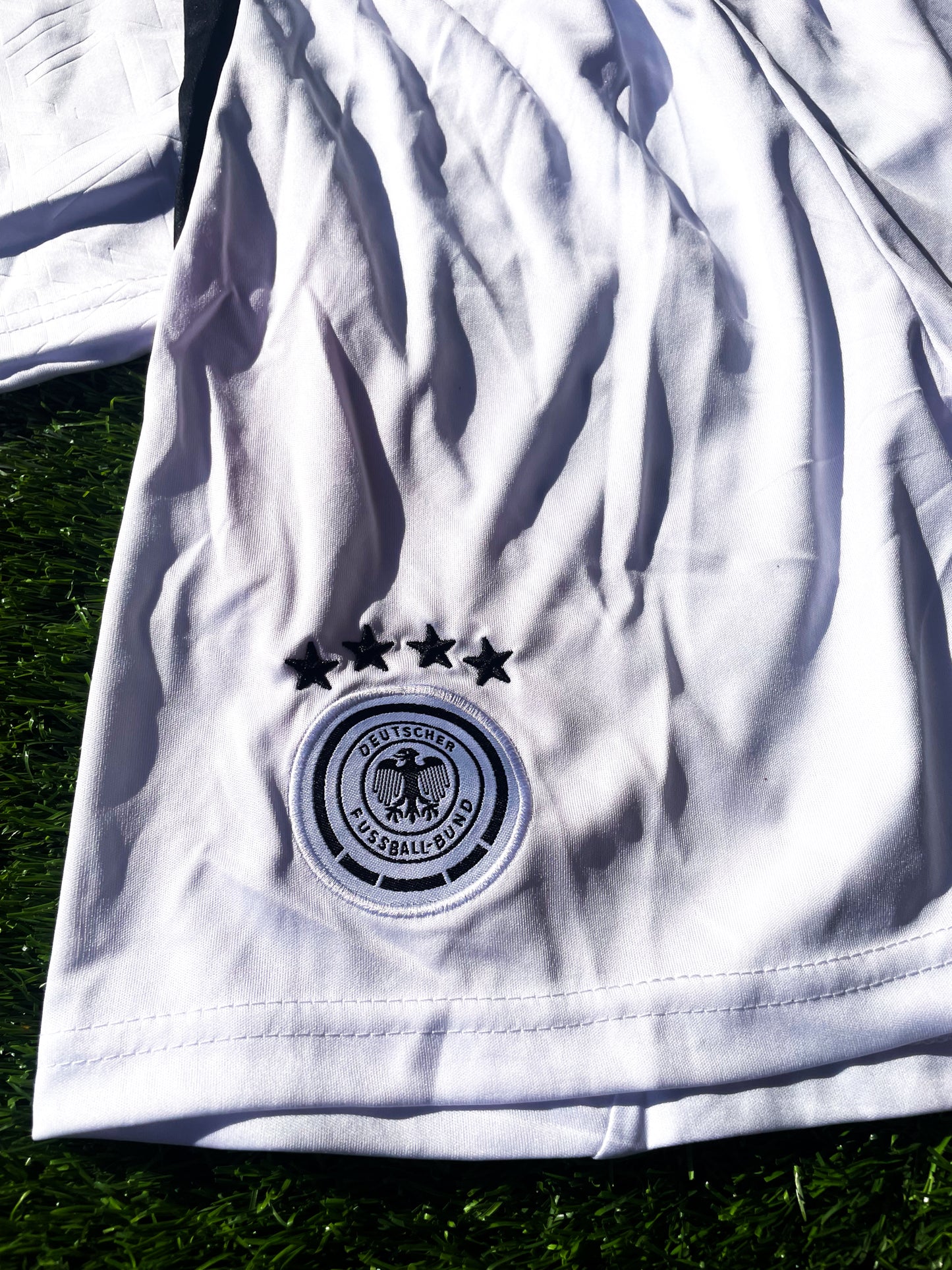 Close-up of Adidas logo and DFB crest on chest