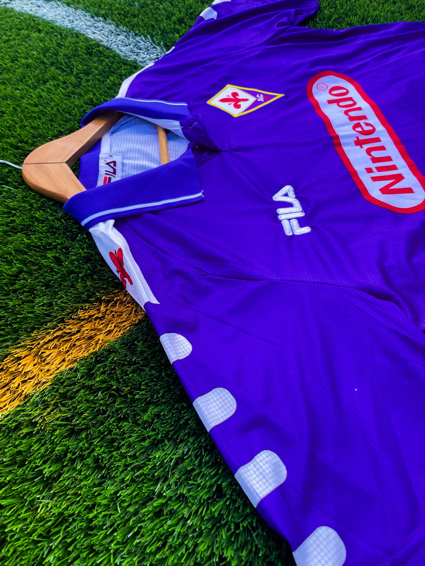 Close-up of embroidered Fiorentina crest and Nintendo logo