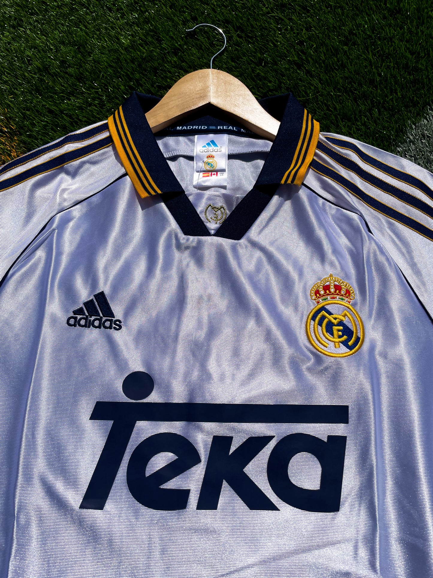 Close-up of embroidered Real Madrid crest and Adidas logo