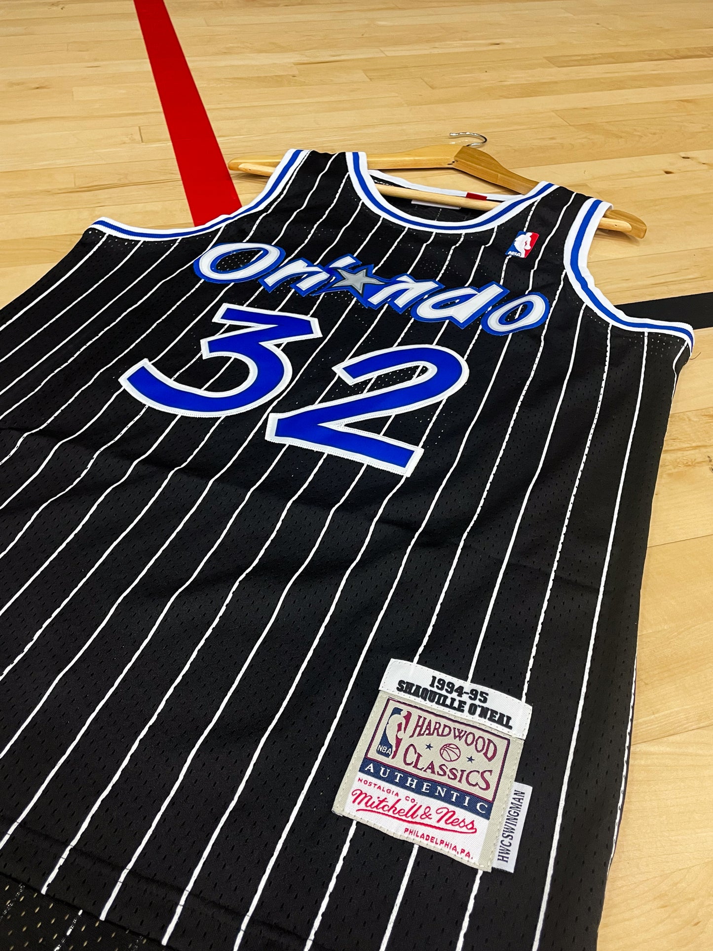 Close-up of the pinstripe design and team logo on the Magic jersey