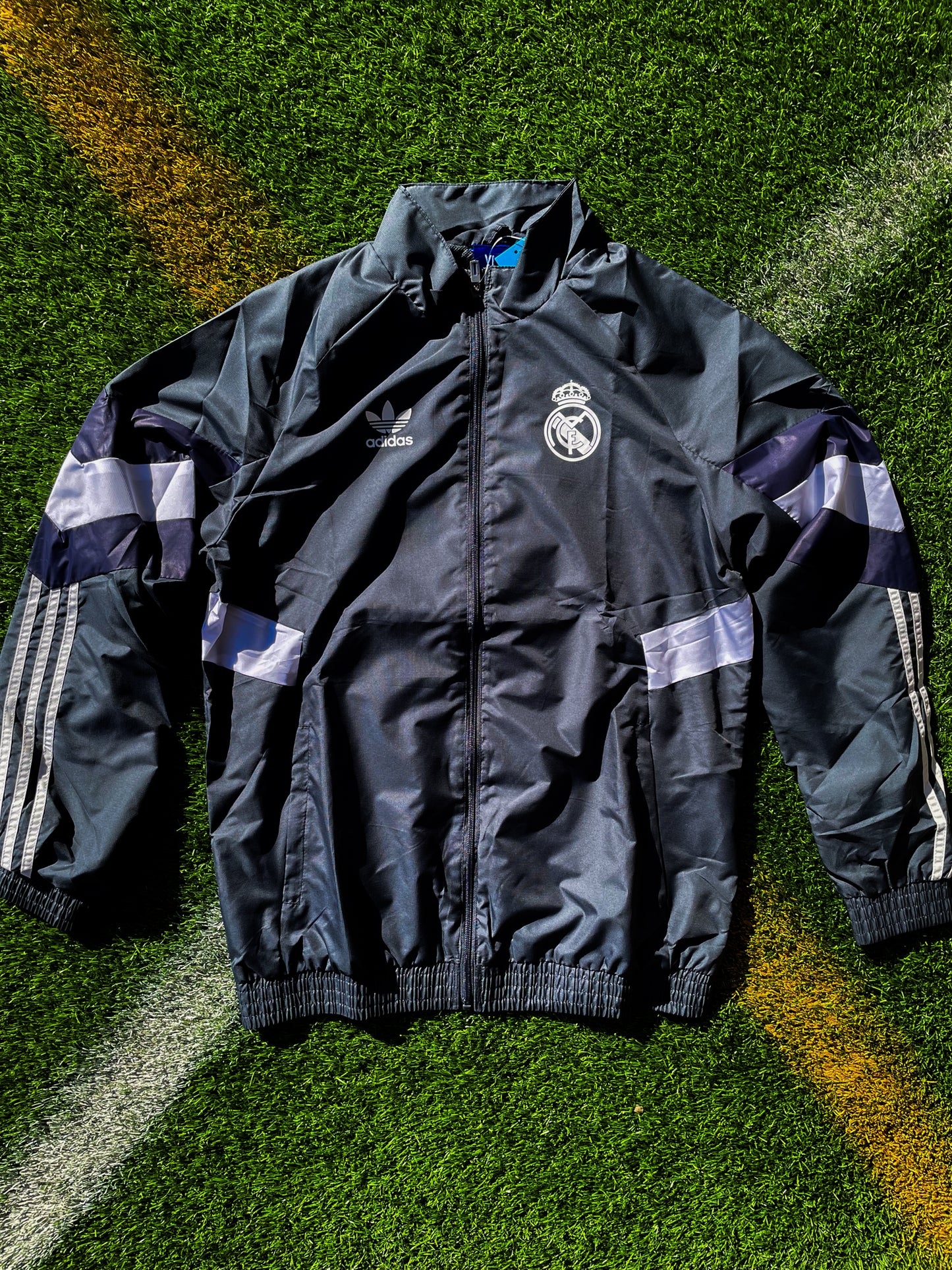 Front view of Real Madrid 2024-2025 gray Adidas training windbreaker