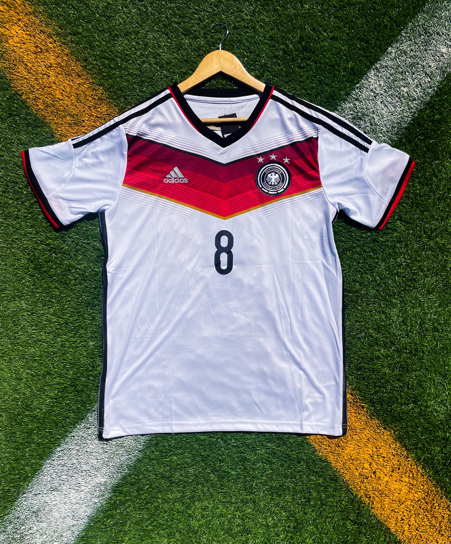 Front of Germany 2014 home jersey with red and black V-shaped graphic