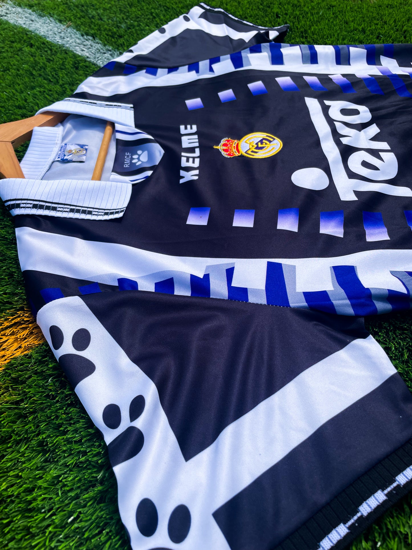 Close-up of Kappa taping and embroidered crest on purple fabric