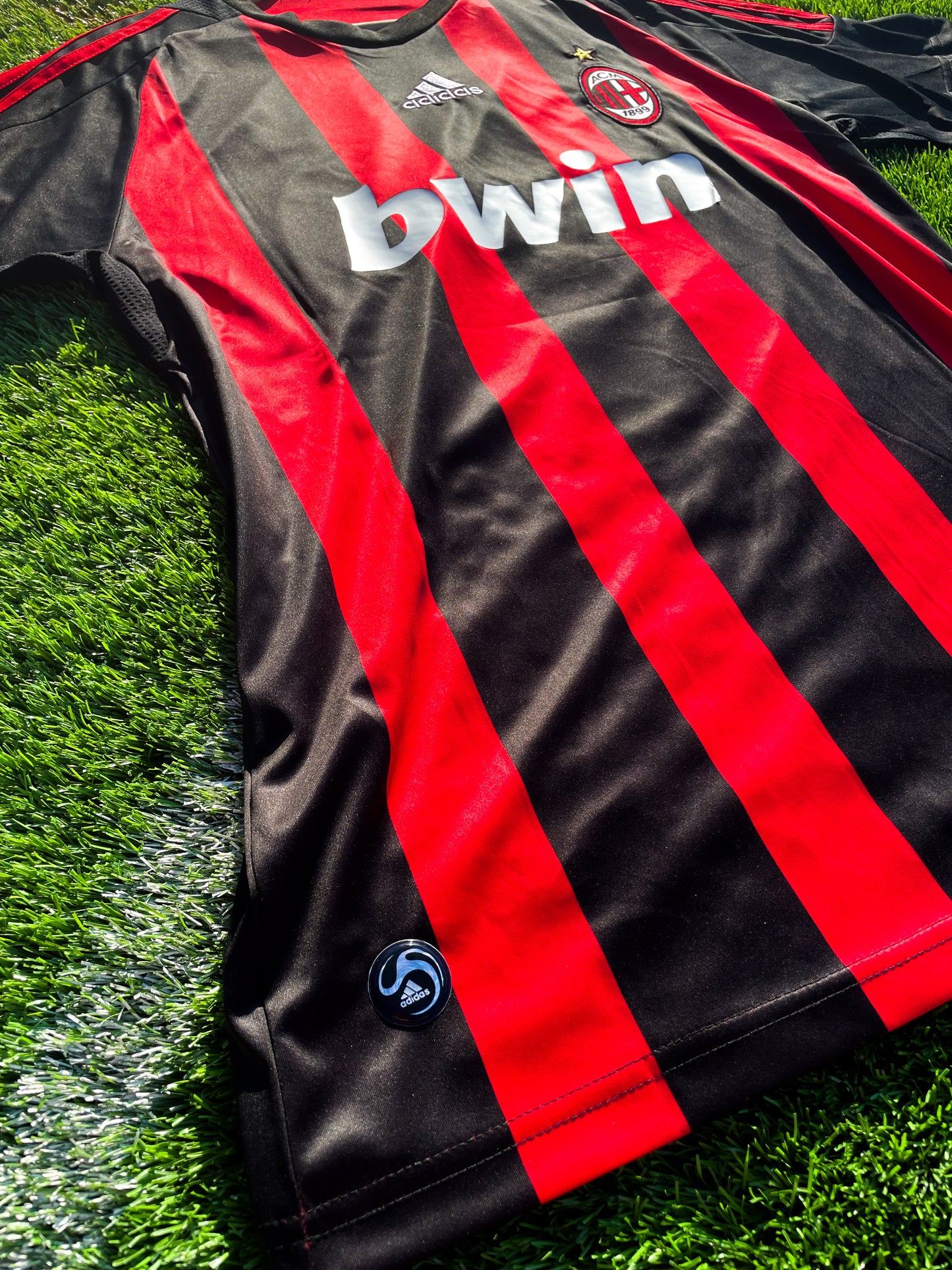 Close-up of Adidas stripes and Bwin sponsor logo
