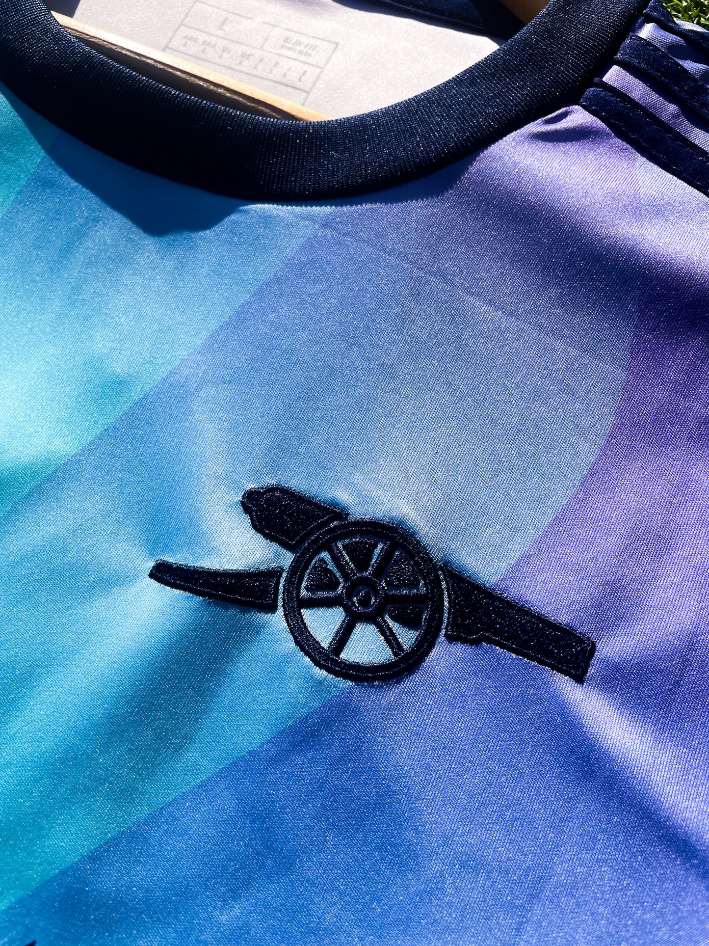 Close-up of Arsenal crest on the bold third kit design