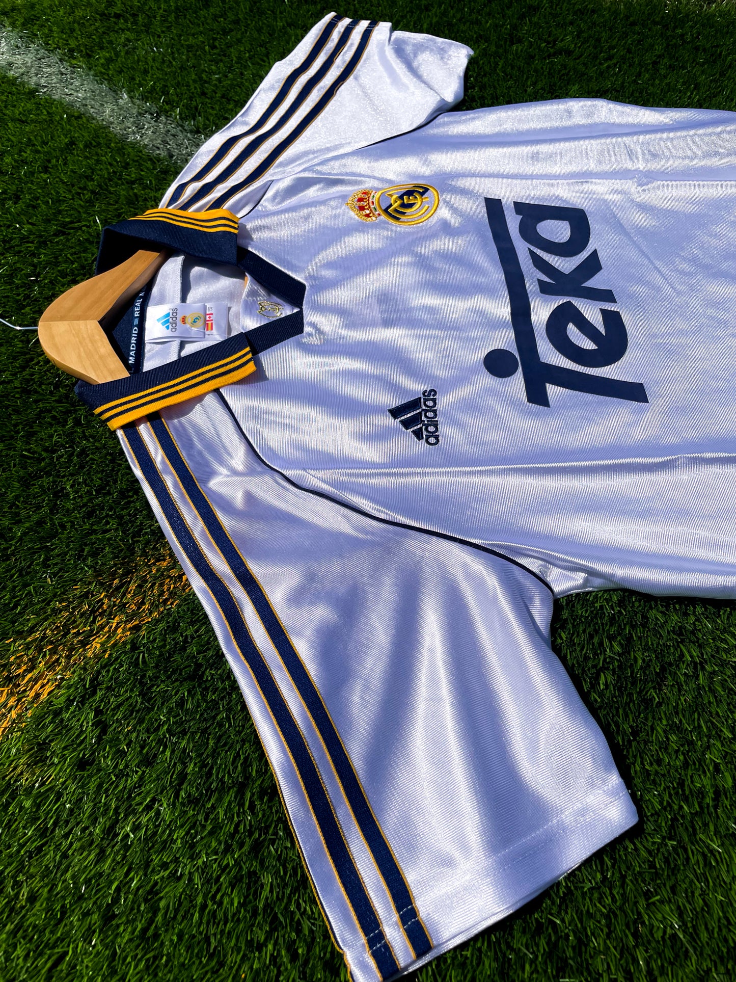 Close-up of embroidered Real Madrid crest and Adidas logo
