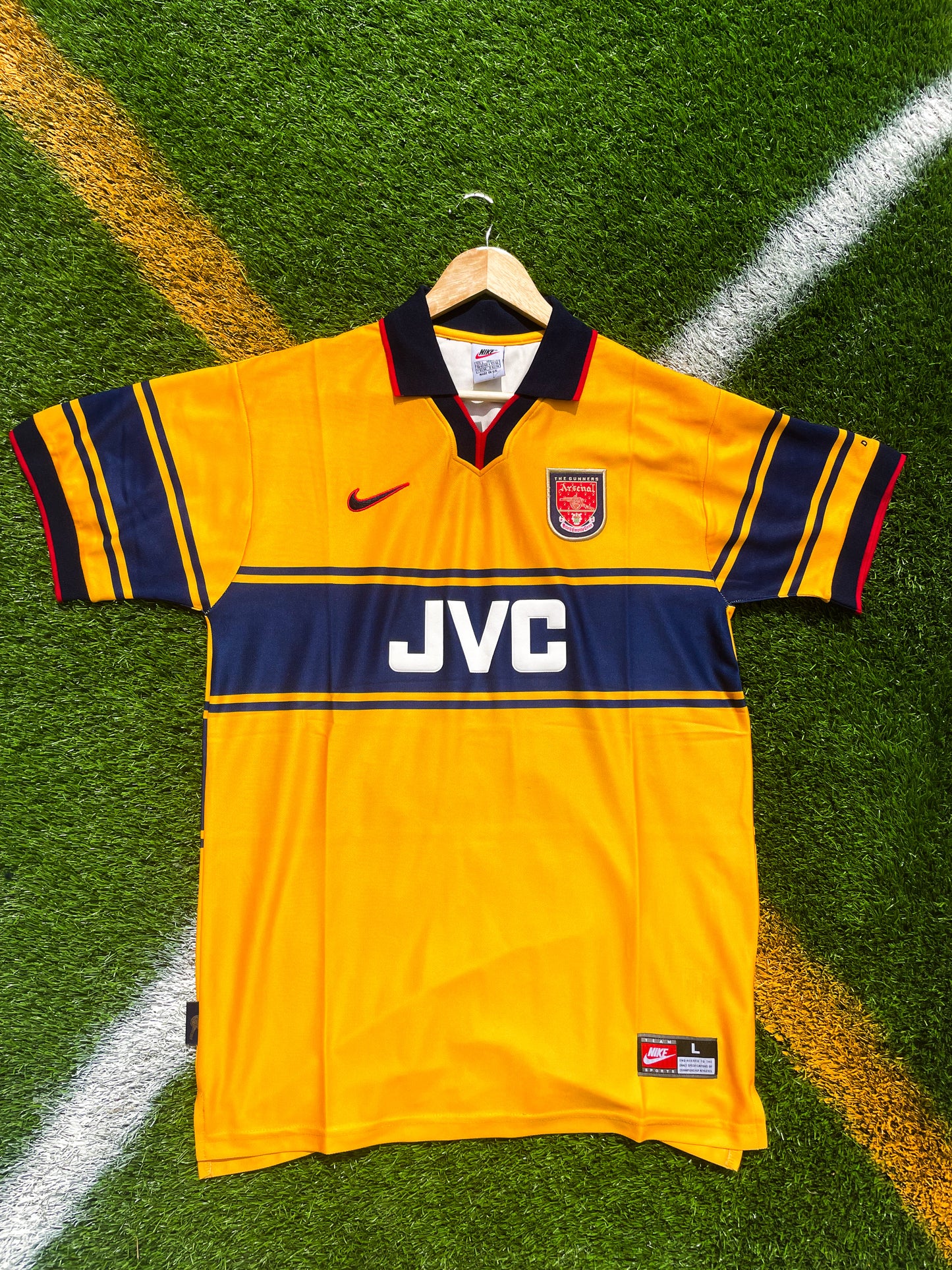 Front view of Arsenal 1997-1998 away jersey in yellow and navy