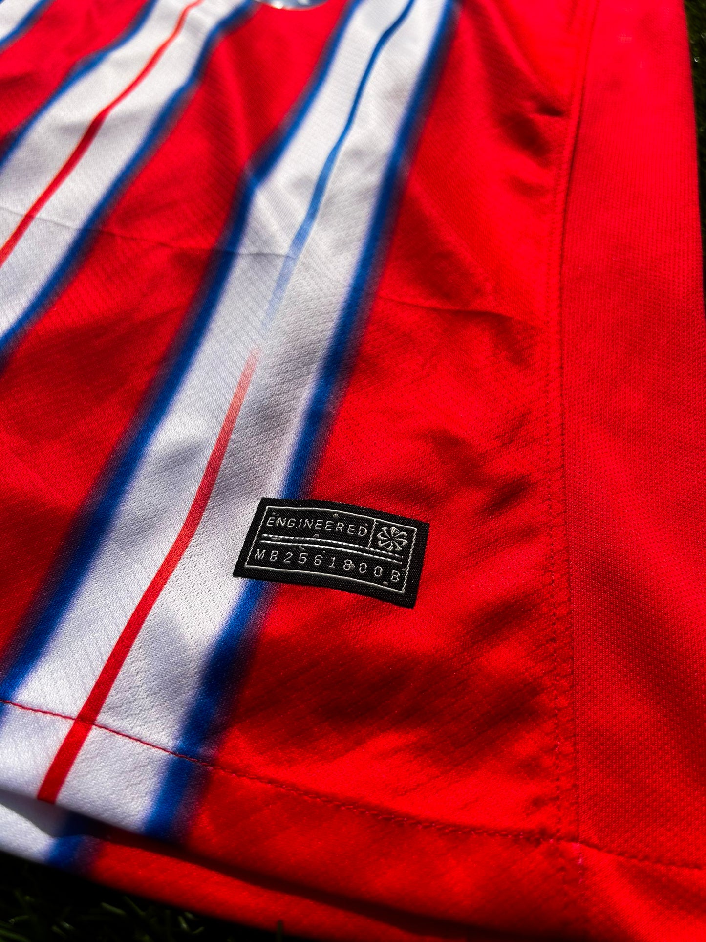 Close-up of Nike logo and Atlético Madrid crest on the 2024-2025 home jersey