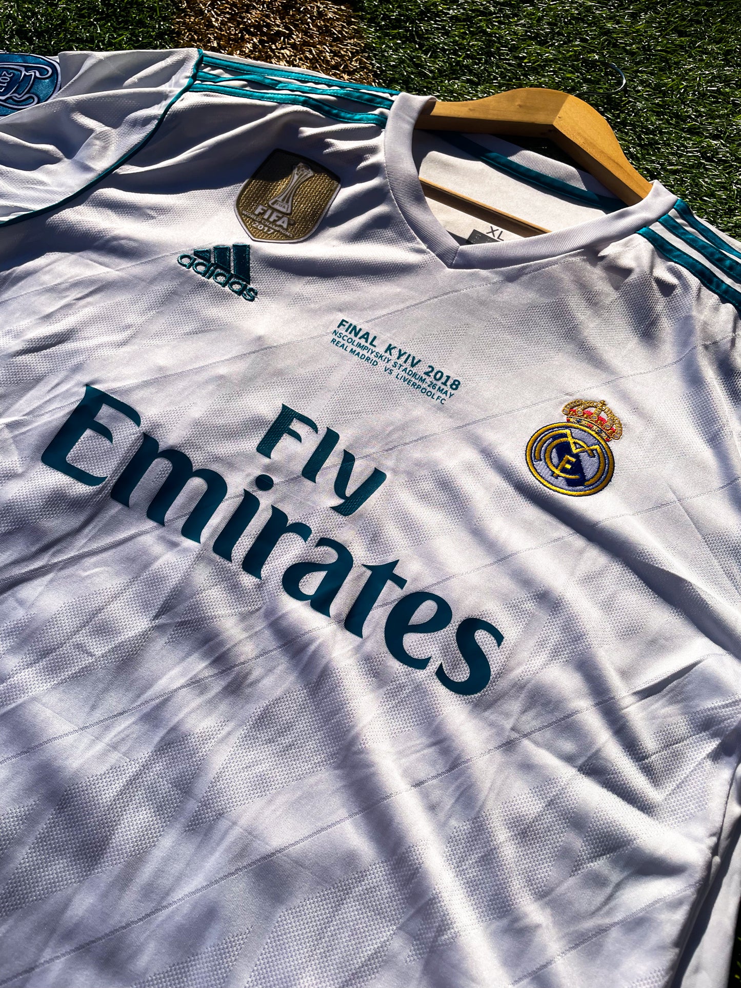 Close-up of embroidered club crest and Nike swoosh on white fabric