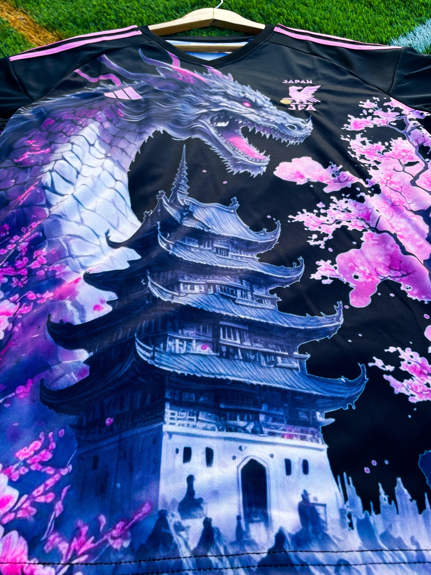 Close-up of vivid pink dragon design on black fabric