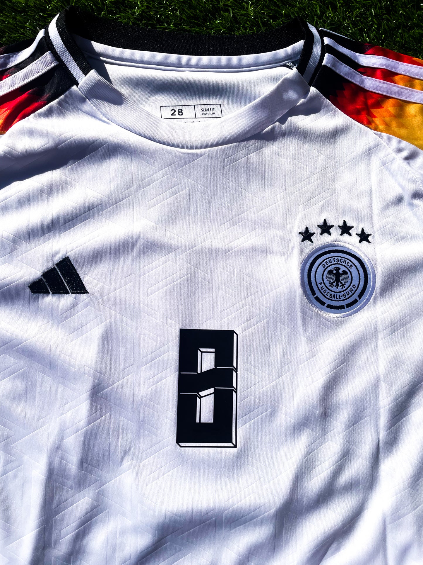 Close-up of Adidas logo and DFB crest on chest