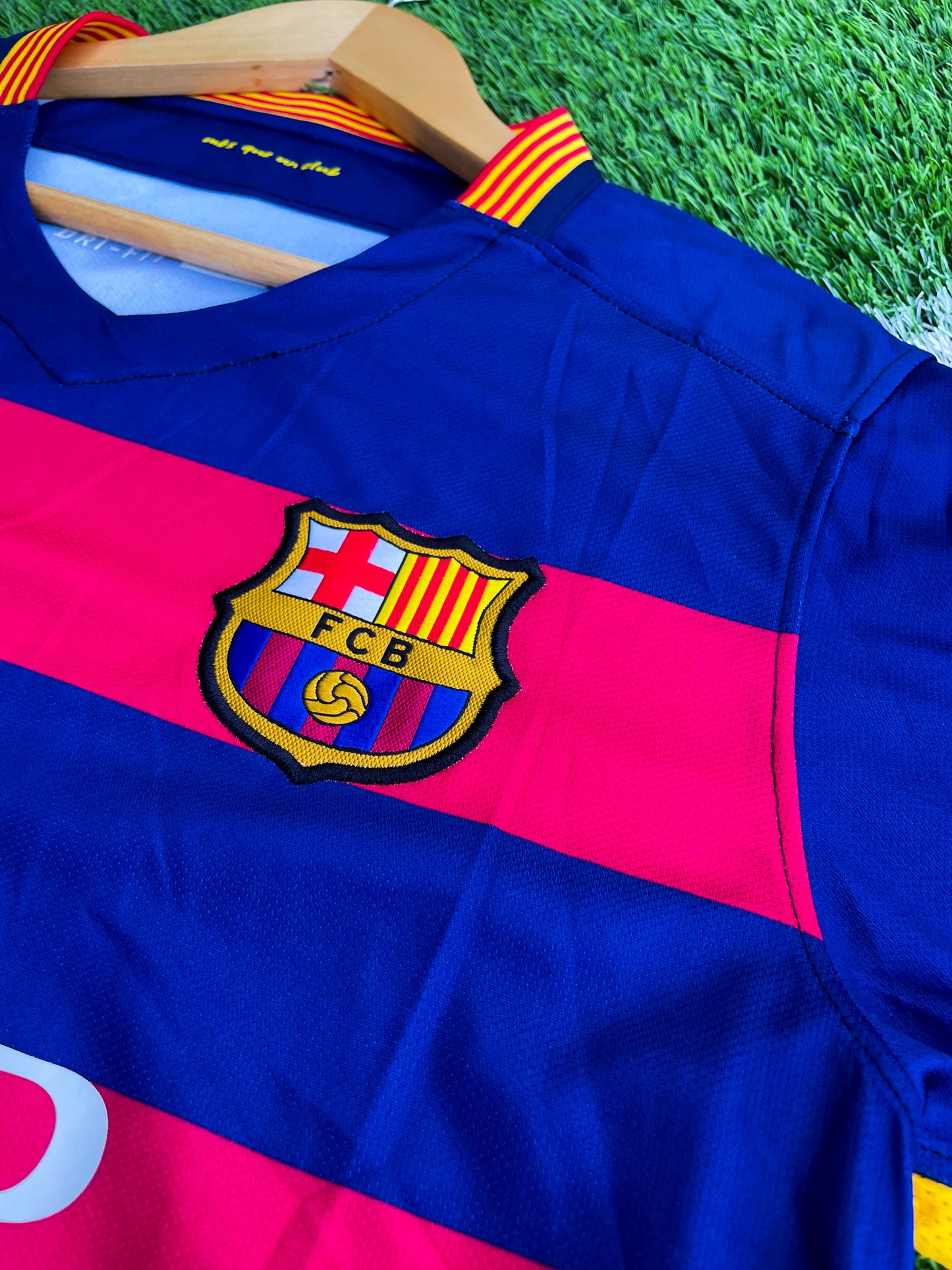 Close-up of Nike logo and Barça crest on red-blue stripes