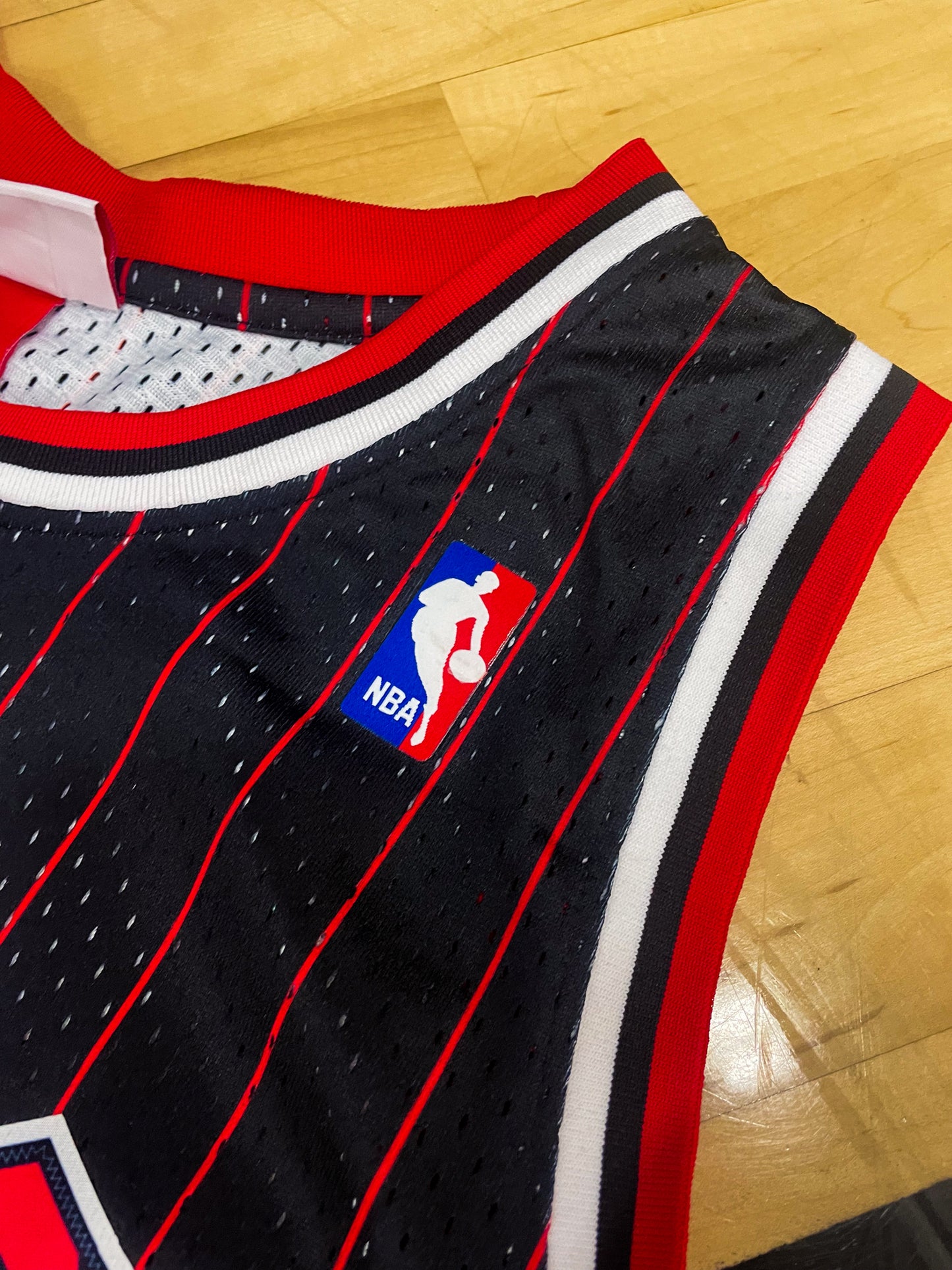 Close-up of Bulls logo and black mesh fabric details with red and white trim