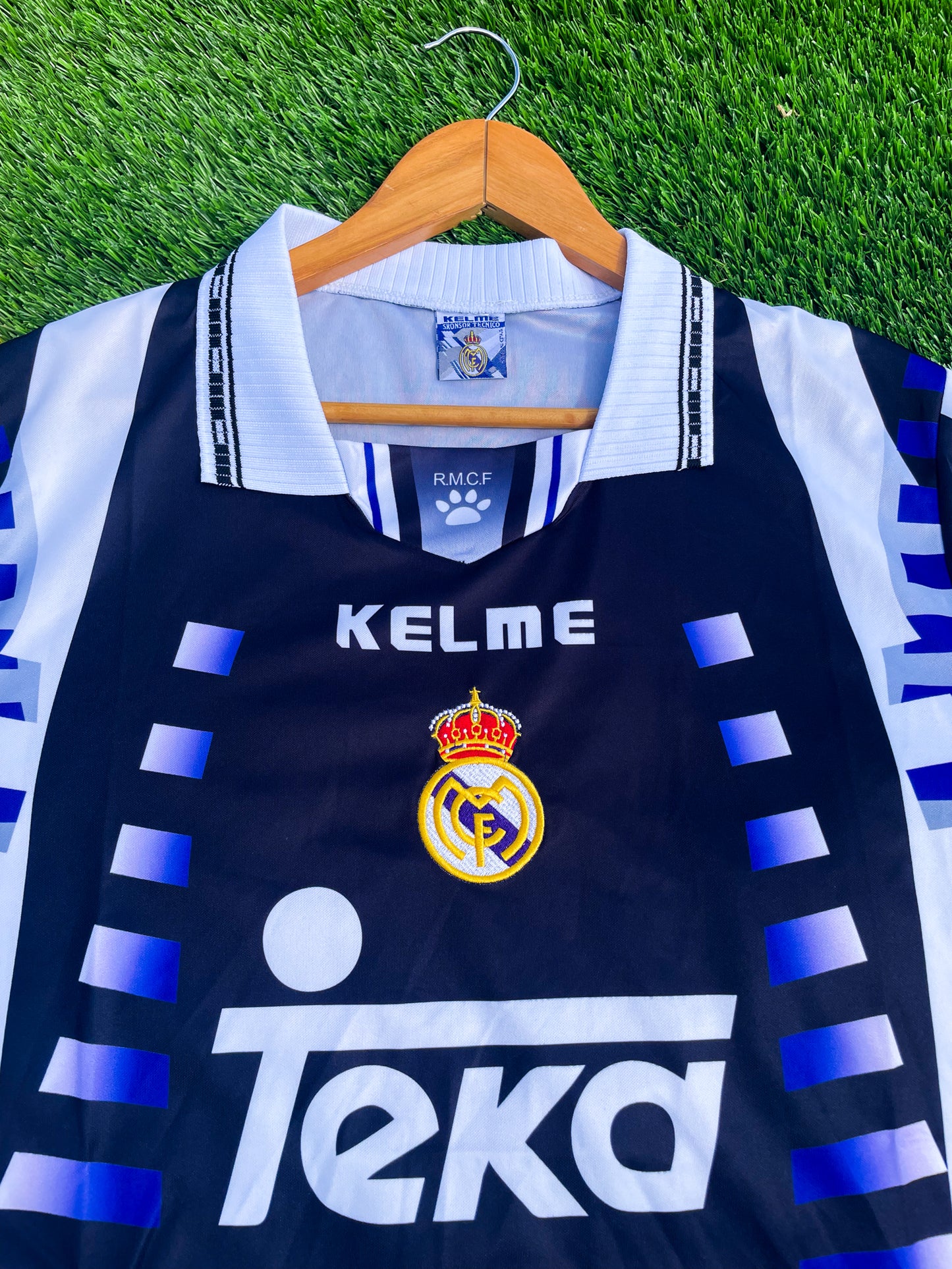 Close-up of Kappa taping and embroidered crest on purple fabric
