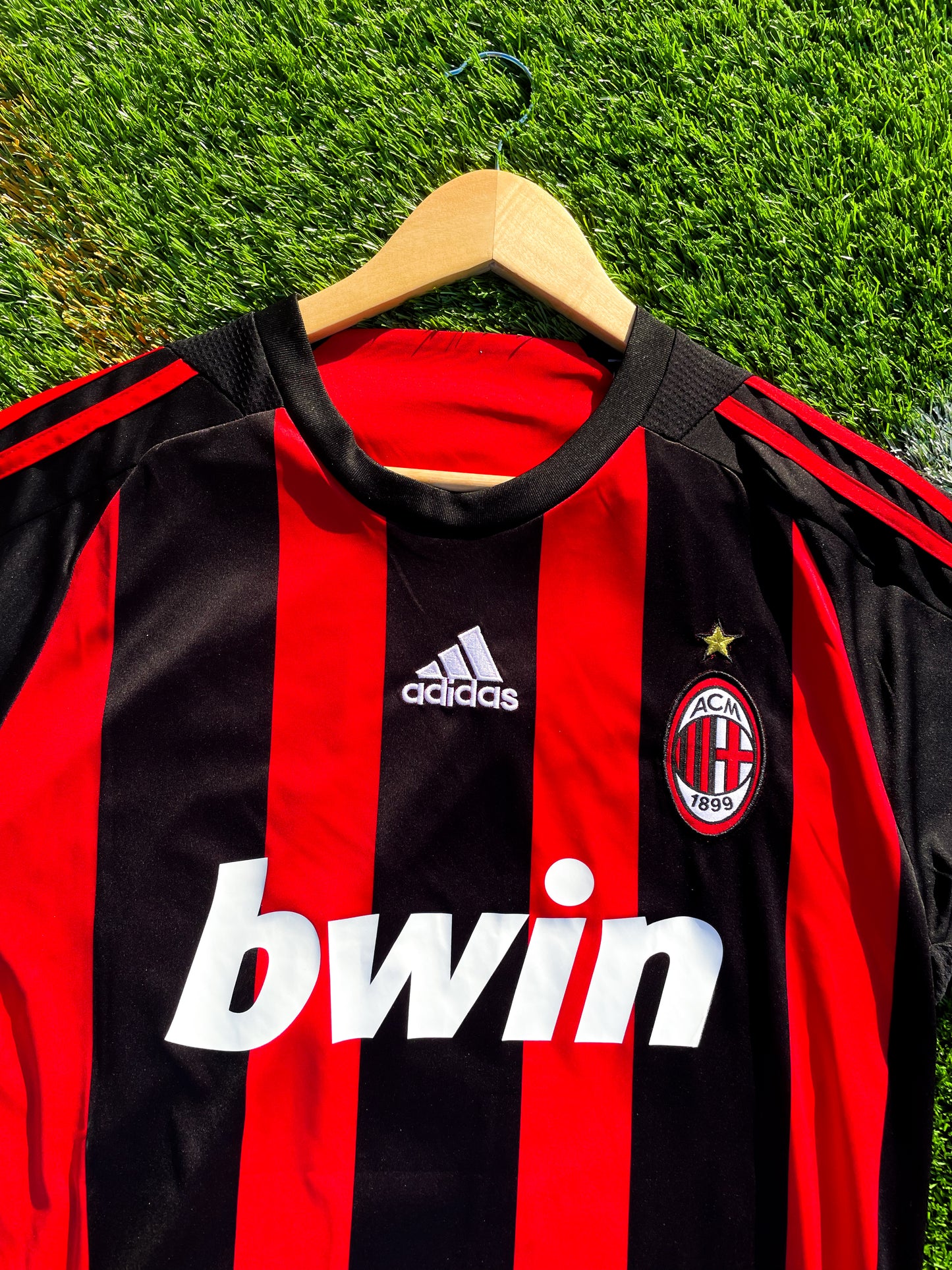 Close-up of Adidas stripes and Bwin sponsor logo