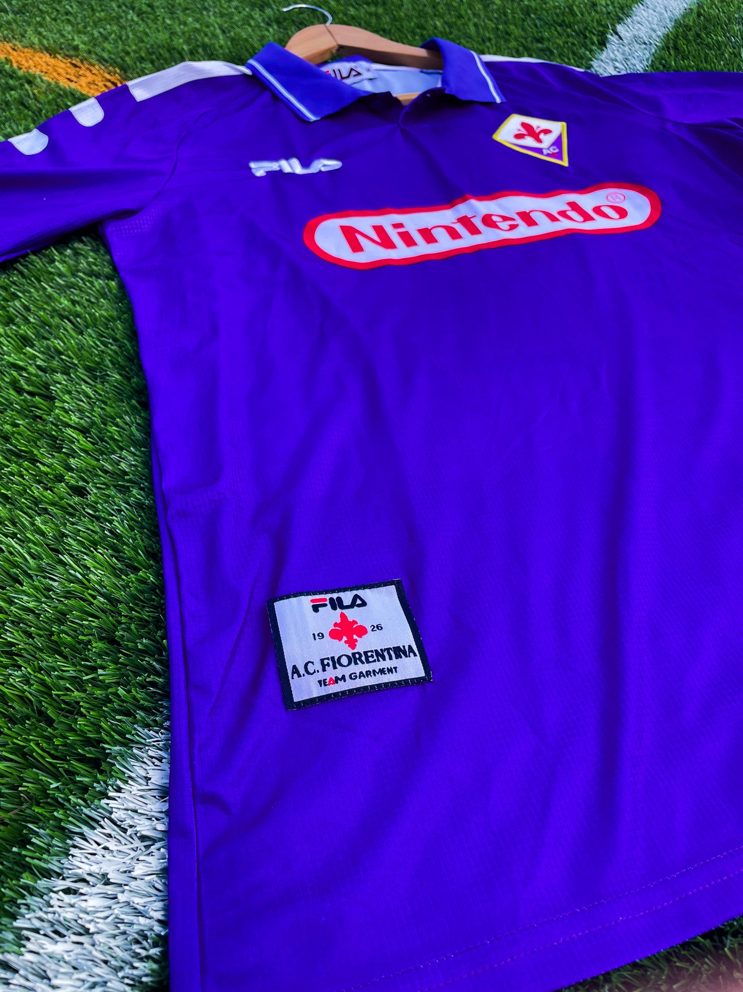 Close-up of embroidered Fiorentina crest and Nintendo logo