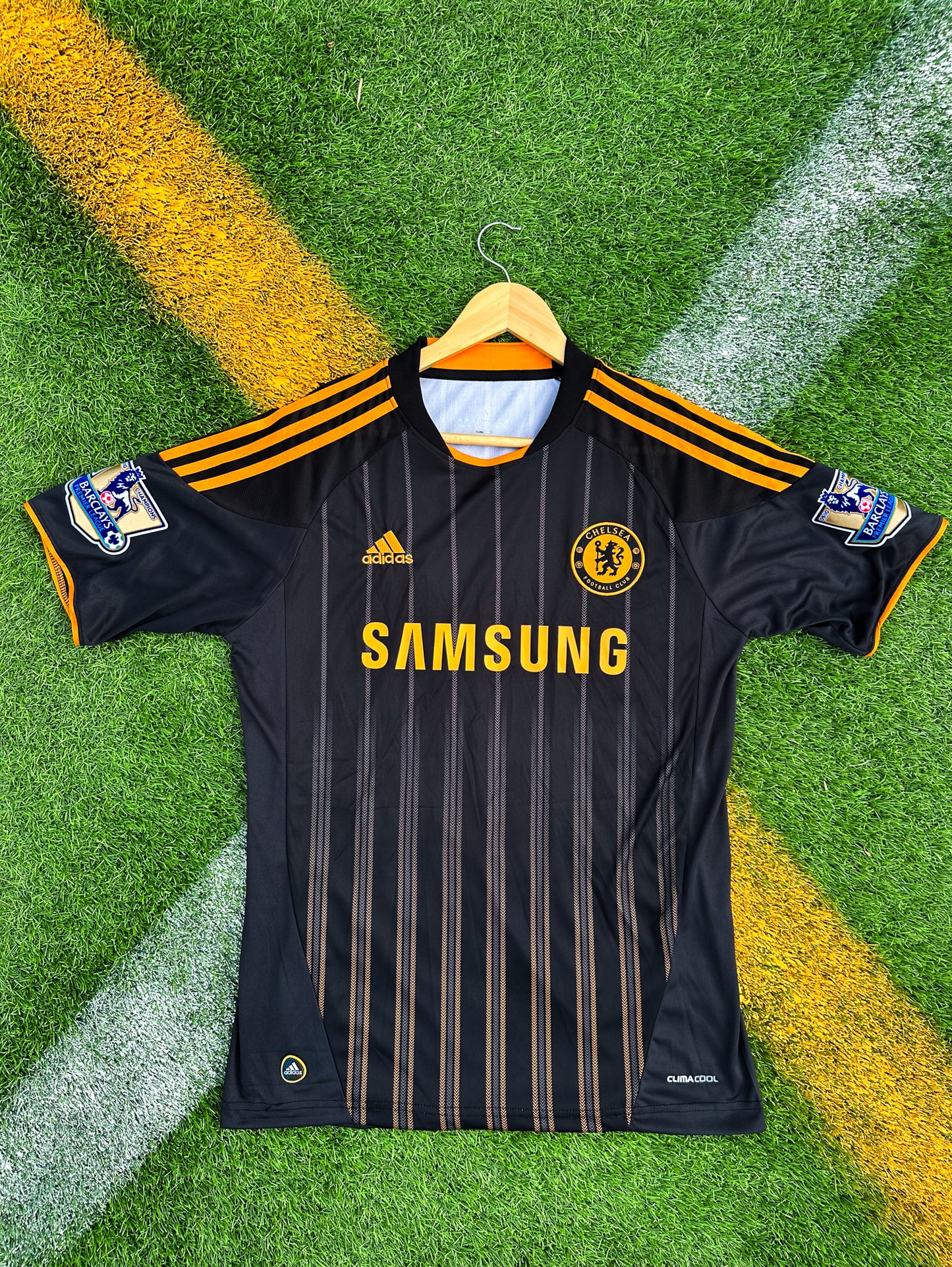 Front view of Chelsea 2010–2011 Away Jersey in black with orange Adidas stripes