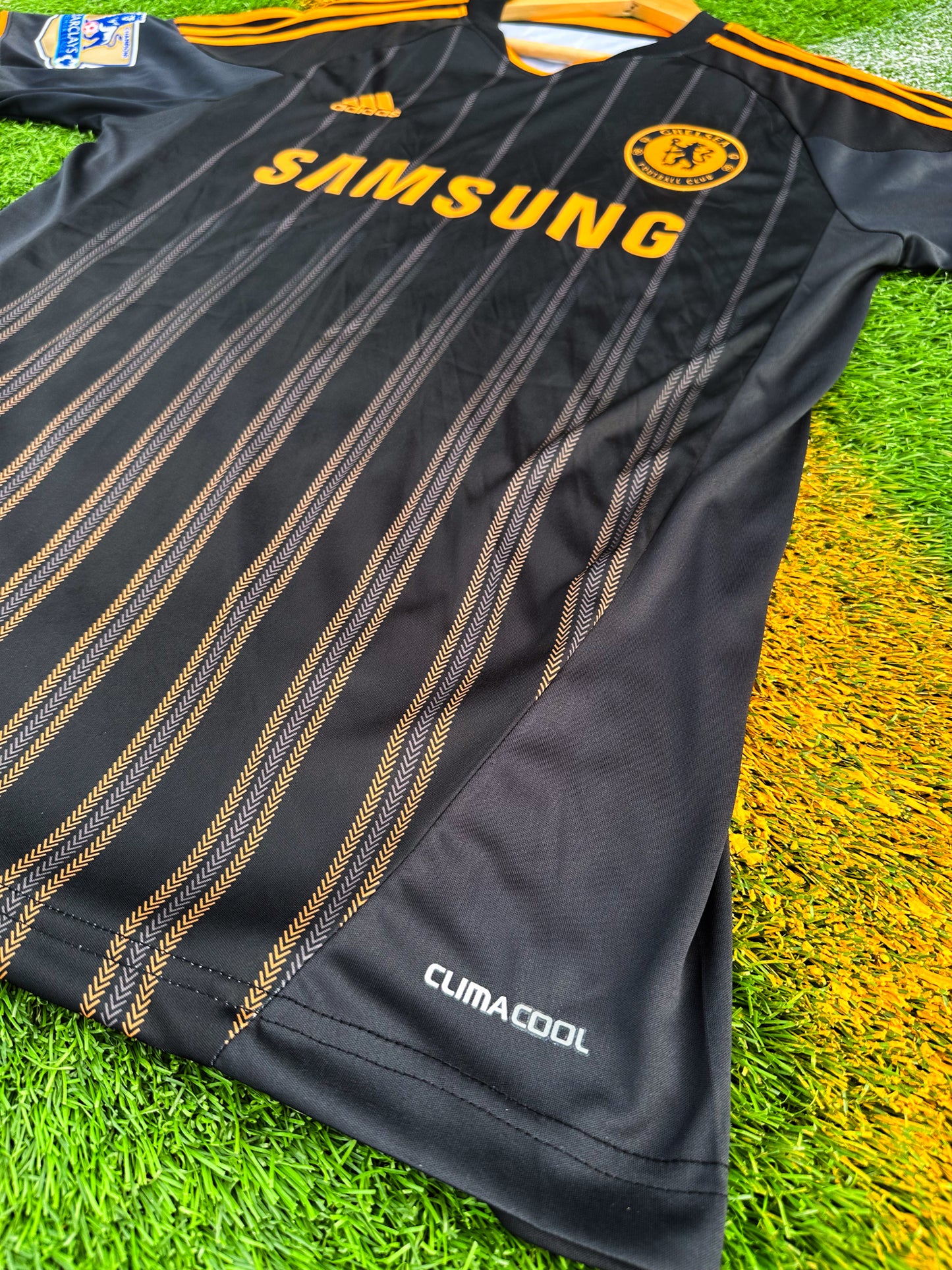 Side angle showing Adidas sleeve stripes and fabric texture