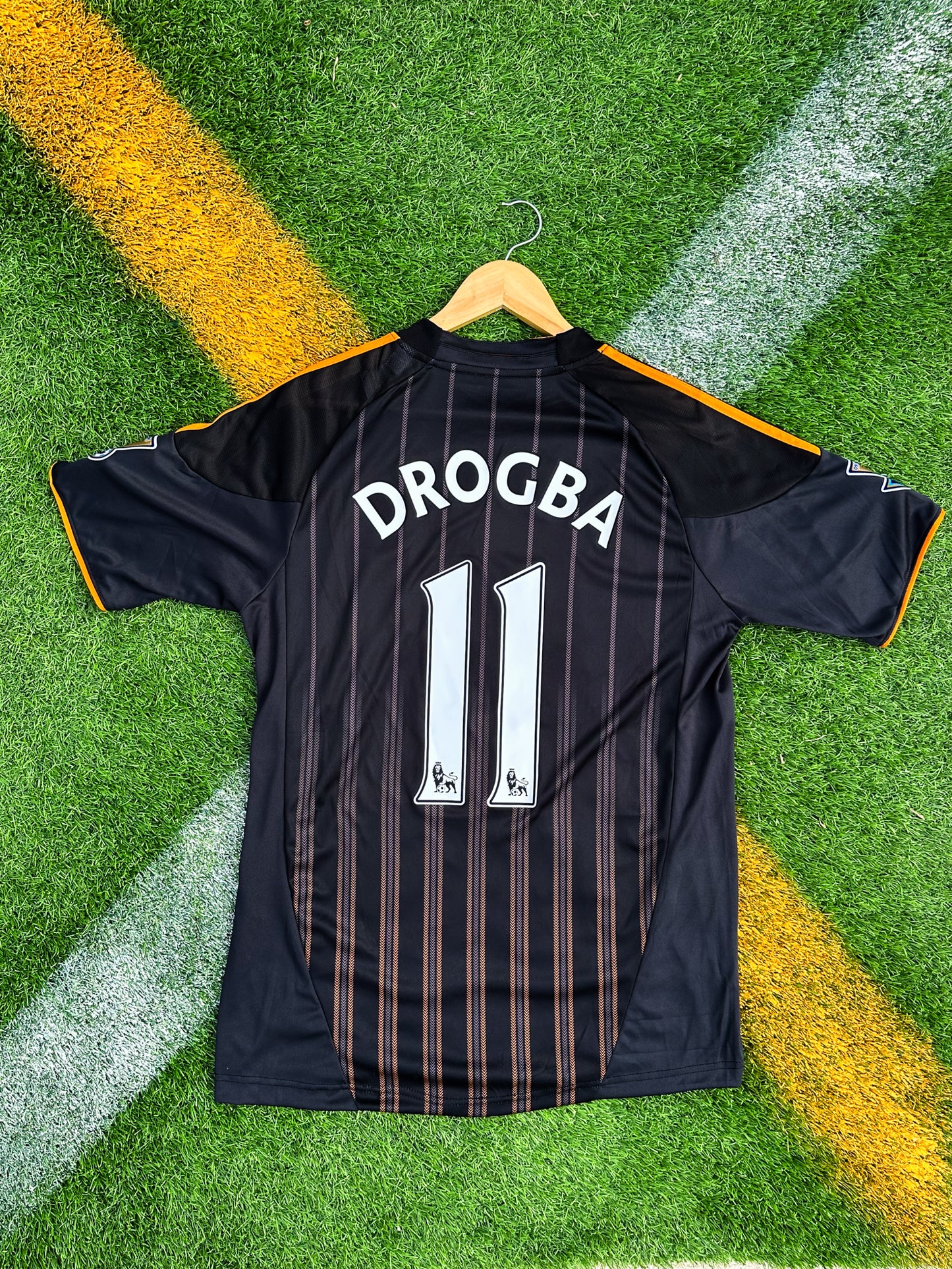 Back view showing Drogba #11 in orange on Chelsea’s black away shirt