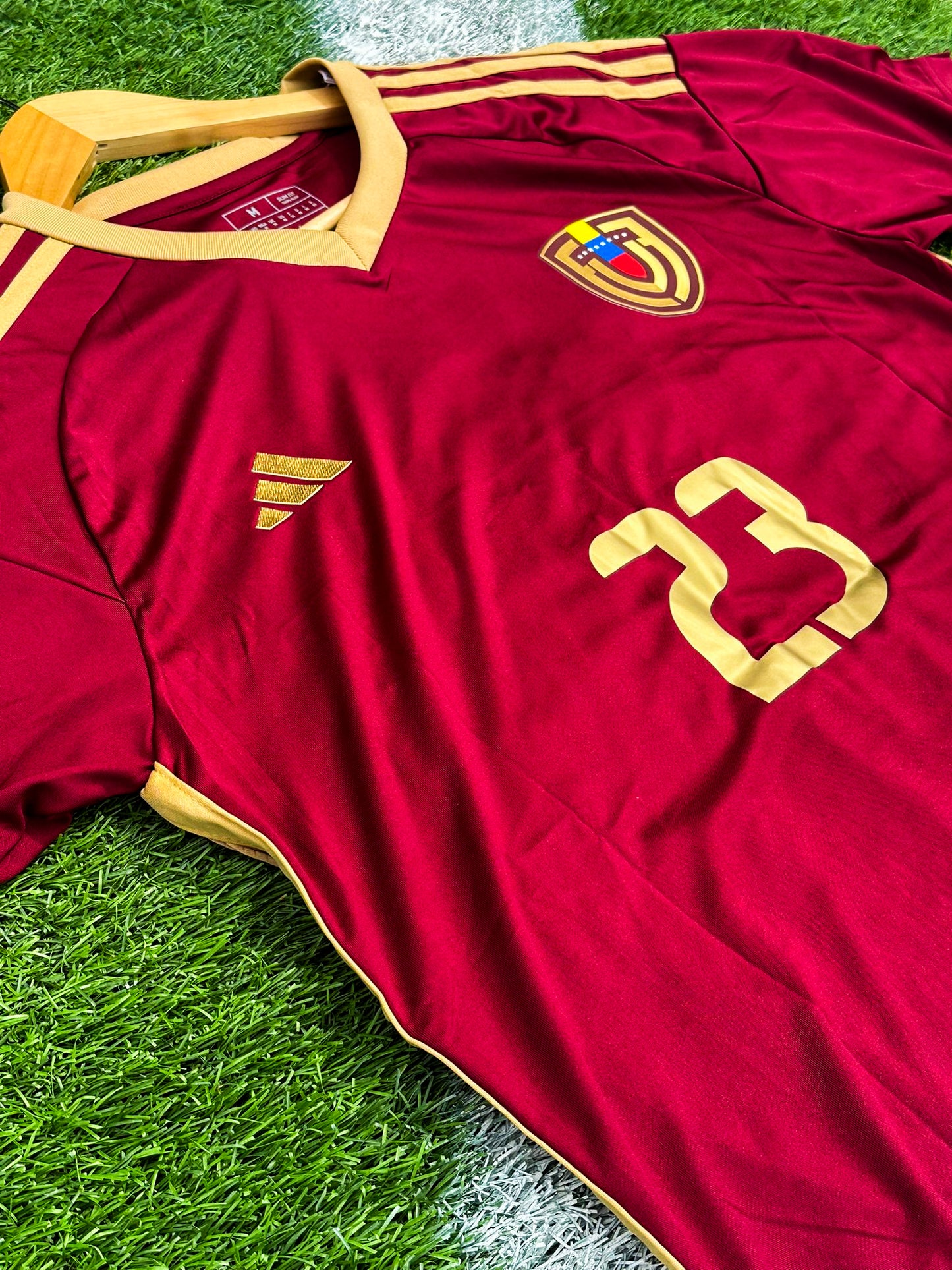 Close-up detail of crest and fabric on Venezuela 2024 Copa America jersey
