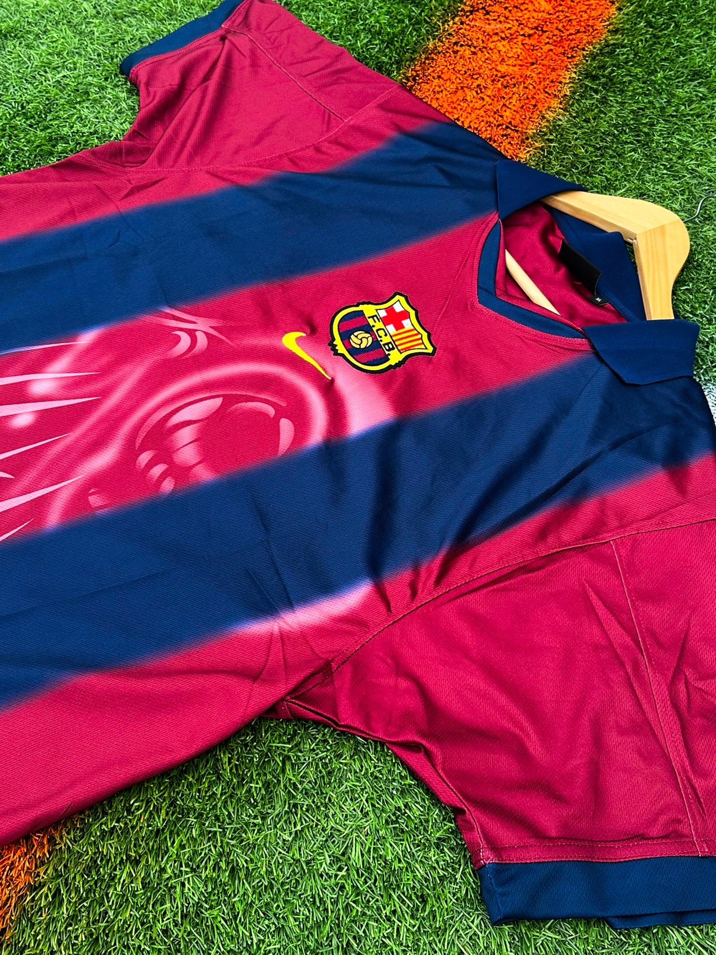 Close-up of Barcelona x Cactus Jack badge and Nike logo on 2024/2025 Home Jersey