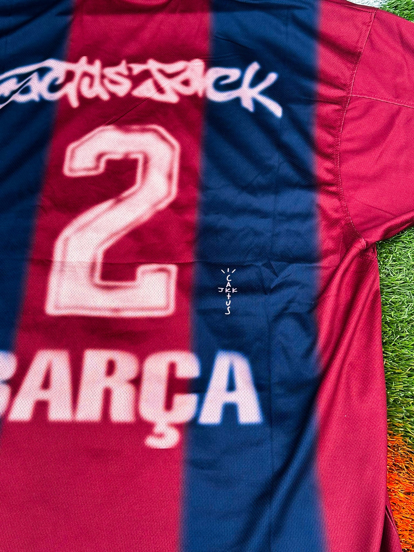 Close-up of Barcelona x Cactus Jack badge and Nike logo on 2024/2025 Home Jersey