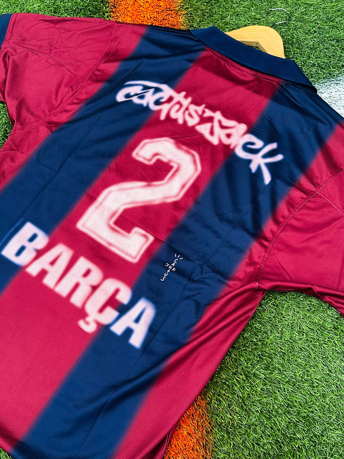Close-up of Barcelona x Cactus Jack badge and Nike logo on 2024/2025 Home Jersey