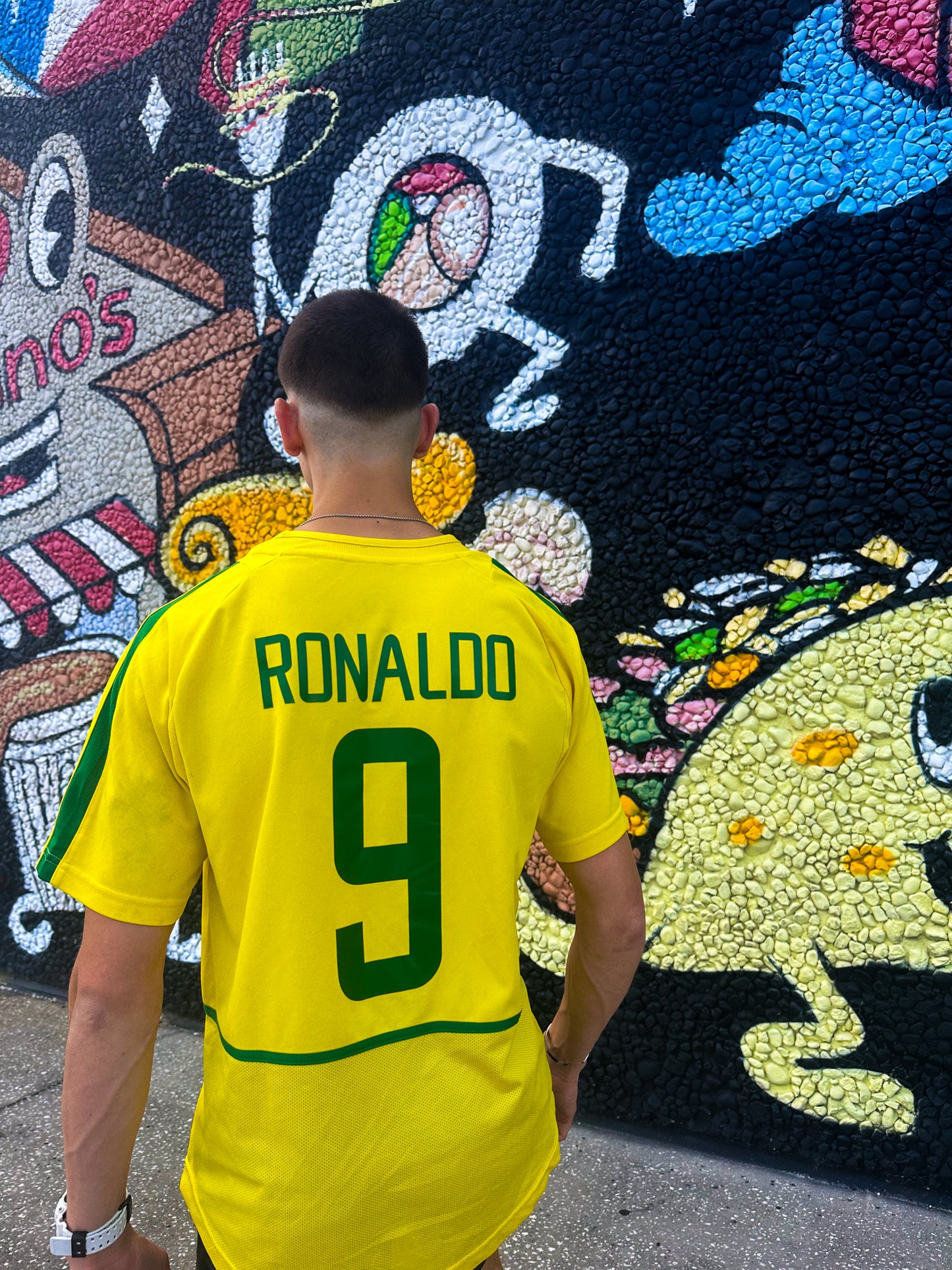 Model wearing the Brazil 2002 Ronaldo & Ronaldinho jerseys styled with sneakers