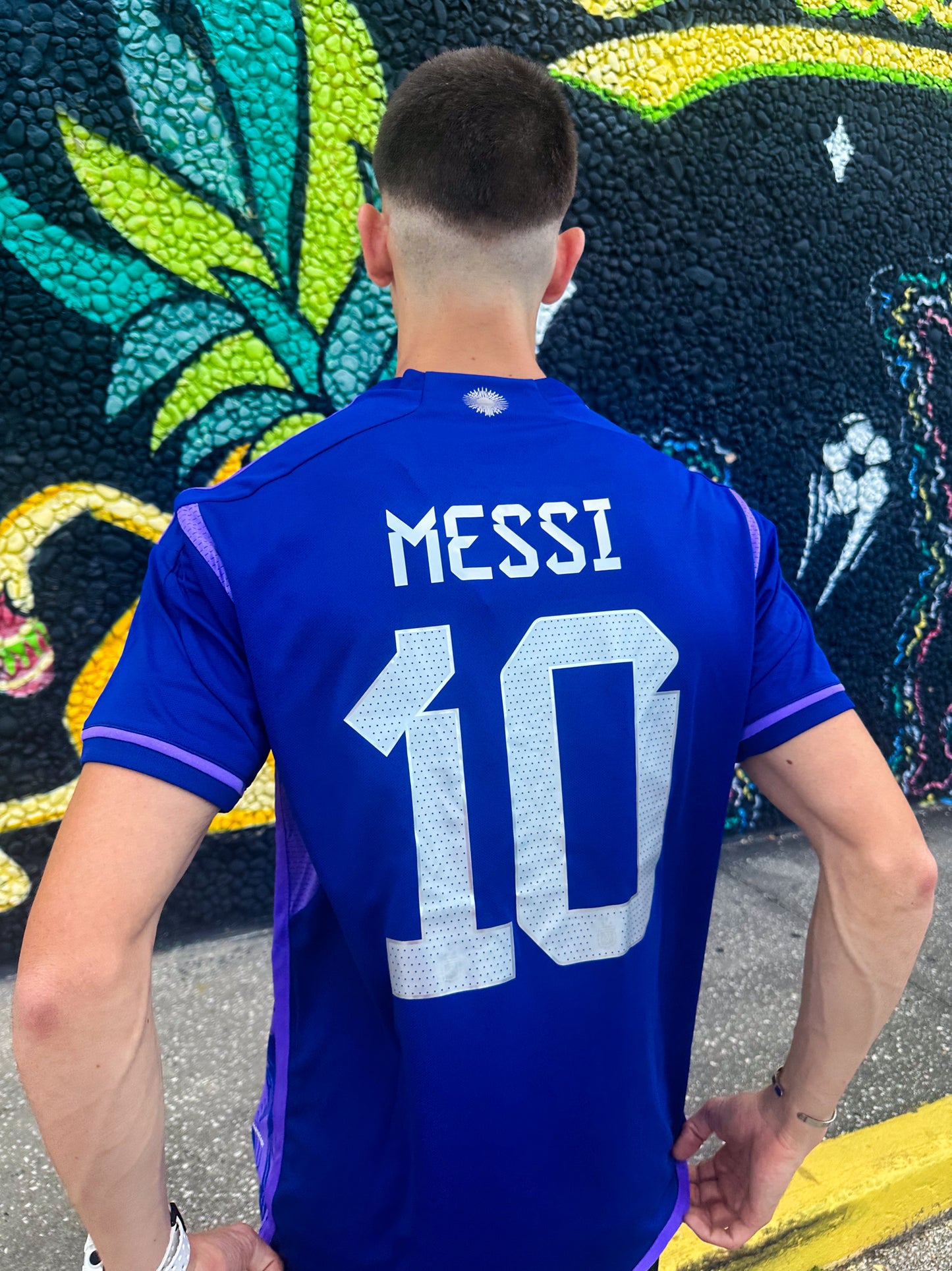 Model wearing Argentina 2023 Away Messi #10 Jersey styled for streetwear.