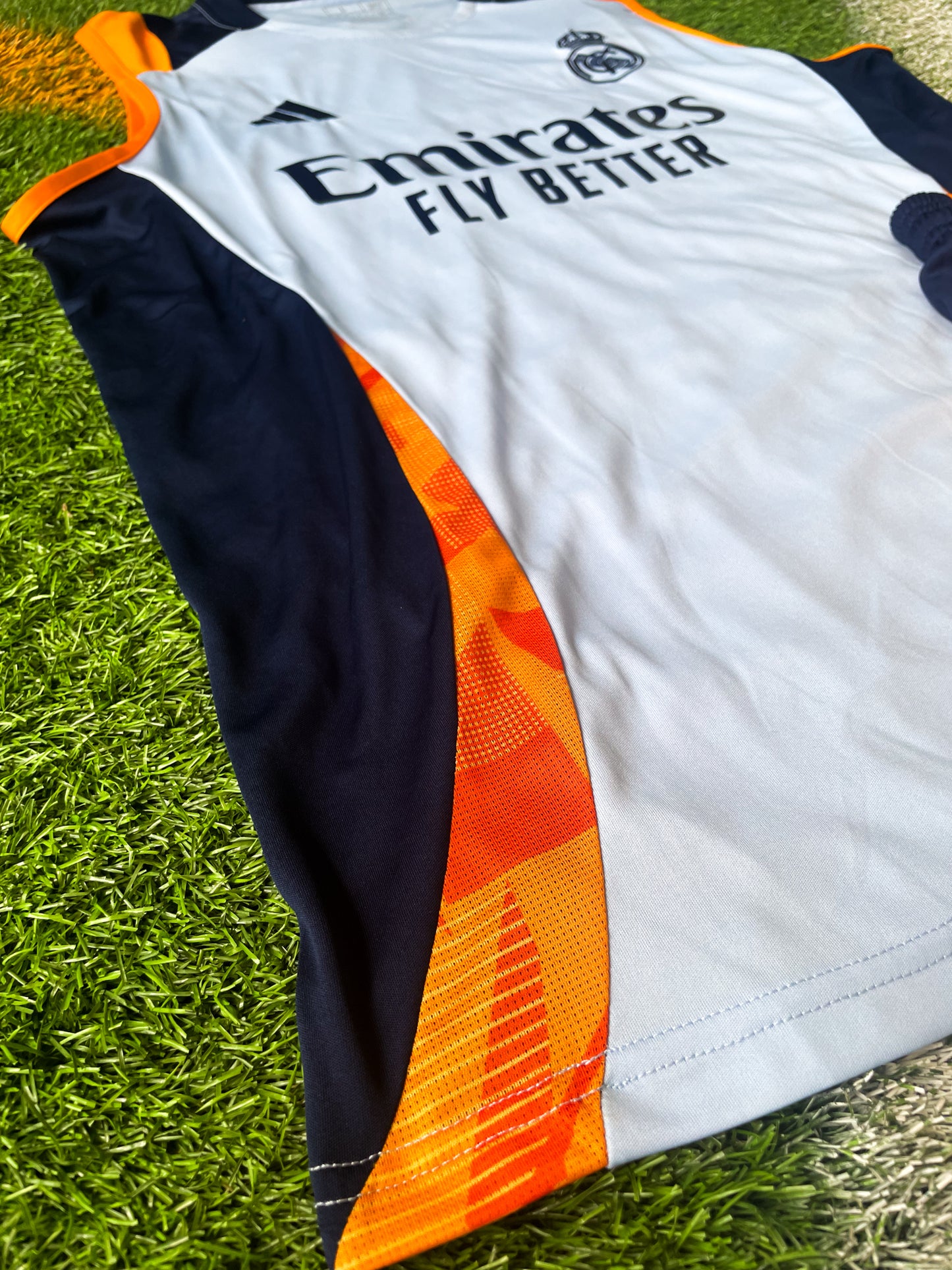 Close-up of Real Madrid crest and Adidas logo on training top