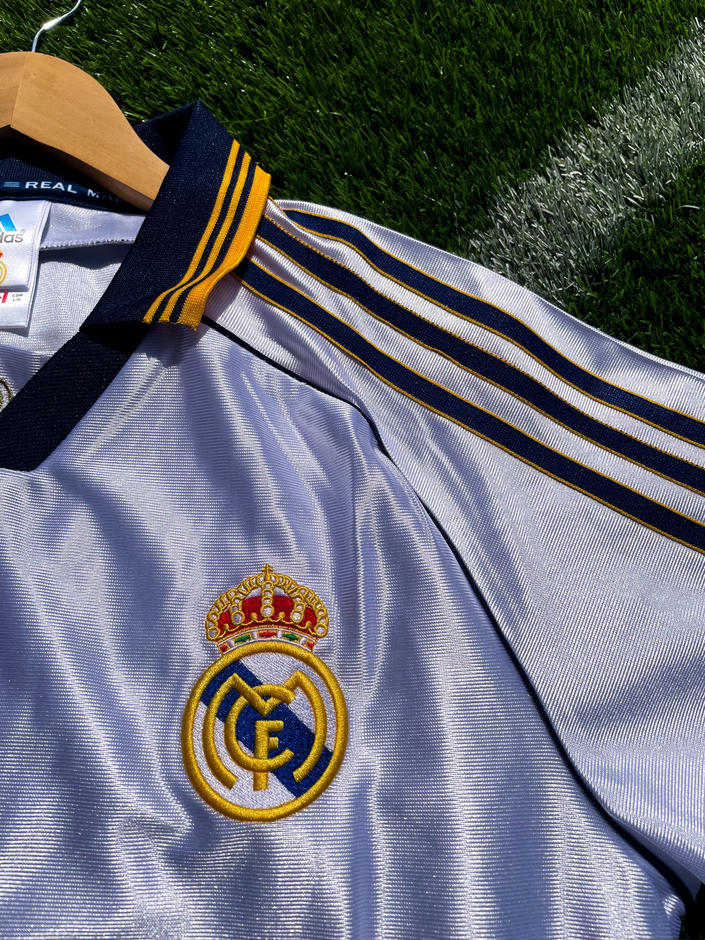 Close-up of embroidered Real Madrid crest and Adidas logo