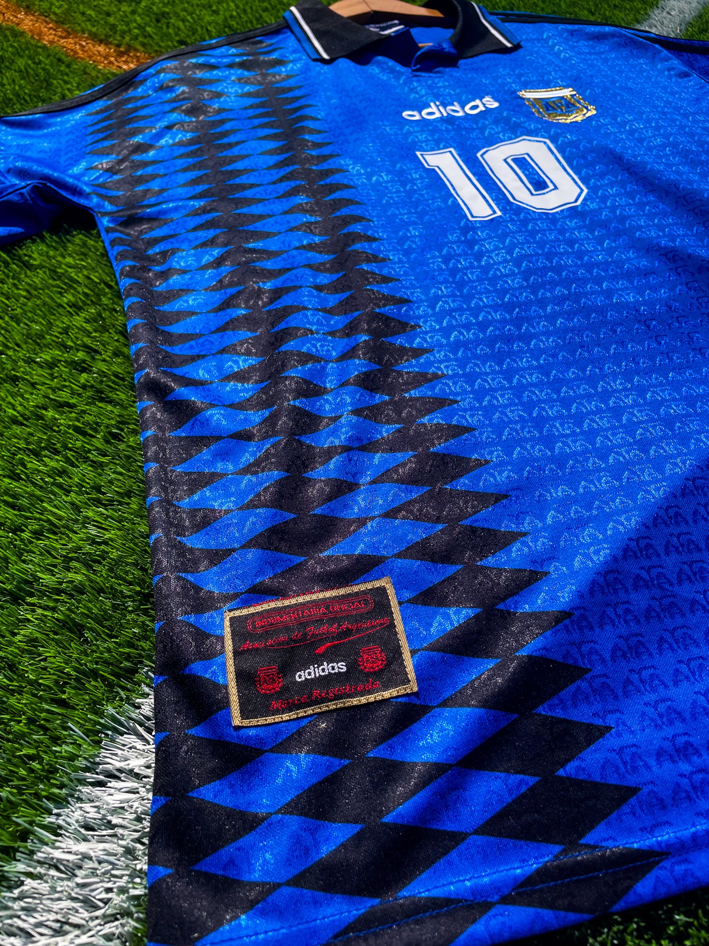 Close-up of Argentina national team crest and Adidas logo on vintage 1994 away jersey