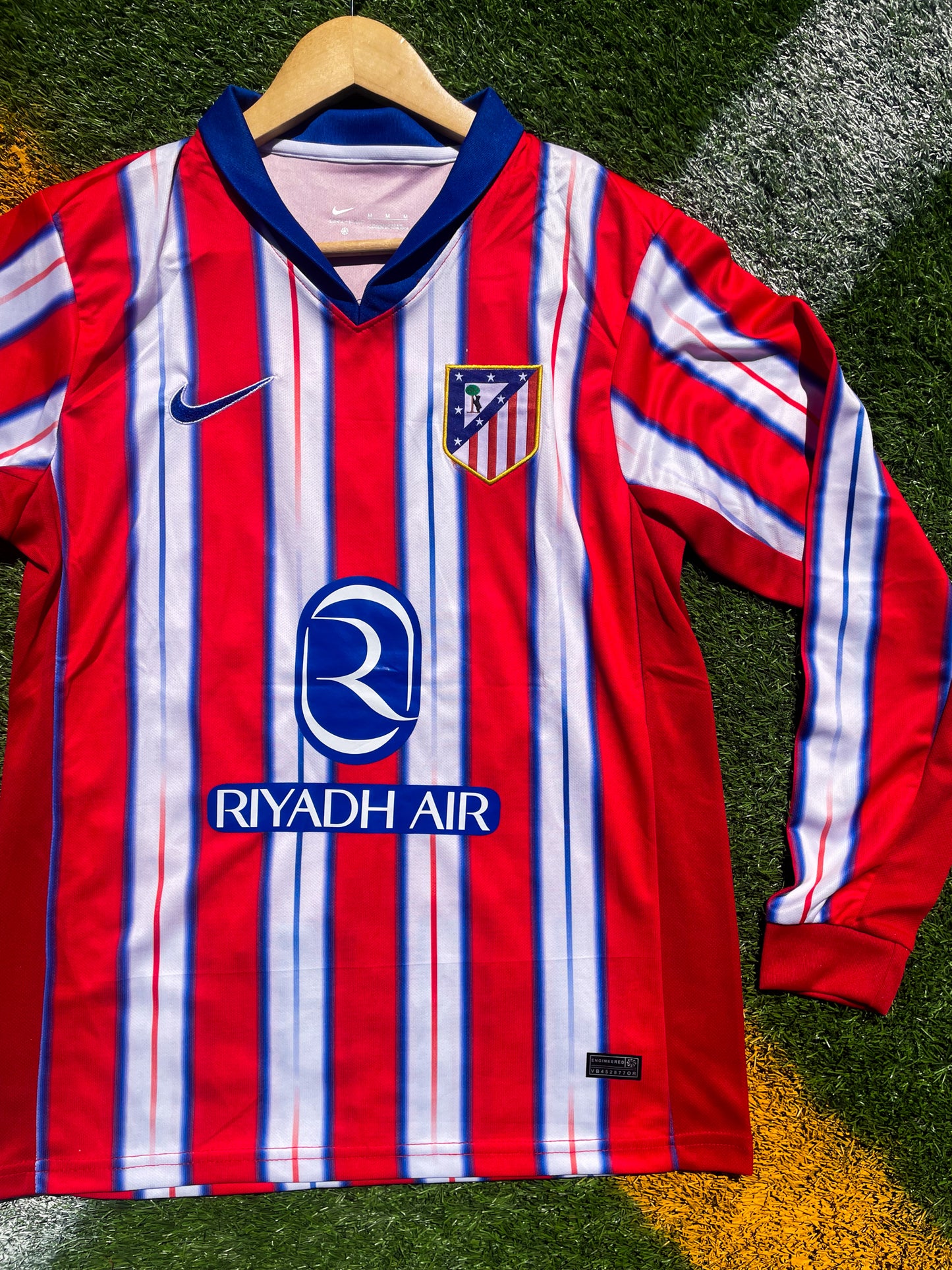 Close-up of Nike logo and Atlético Madrid crest on the 2024-2025 home jersey