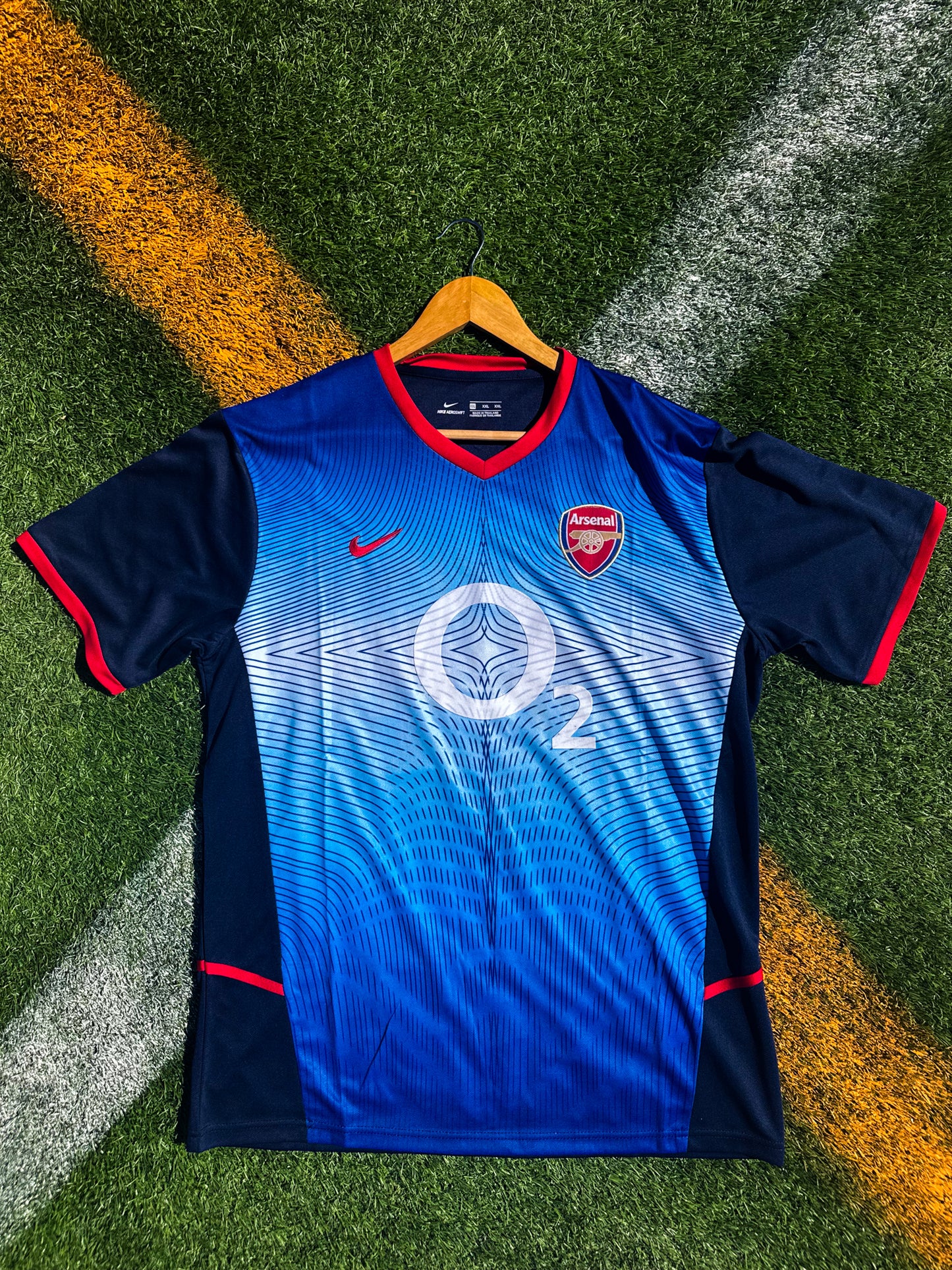 Front view of Arsenal 2002–2003 Away Jersey in blue with yellow collar and Nike swoosh