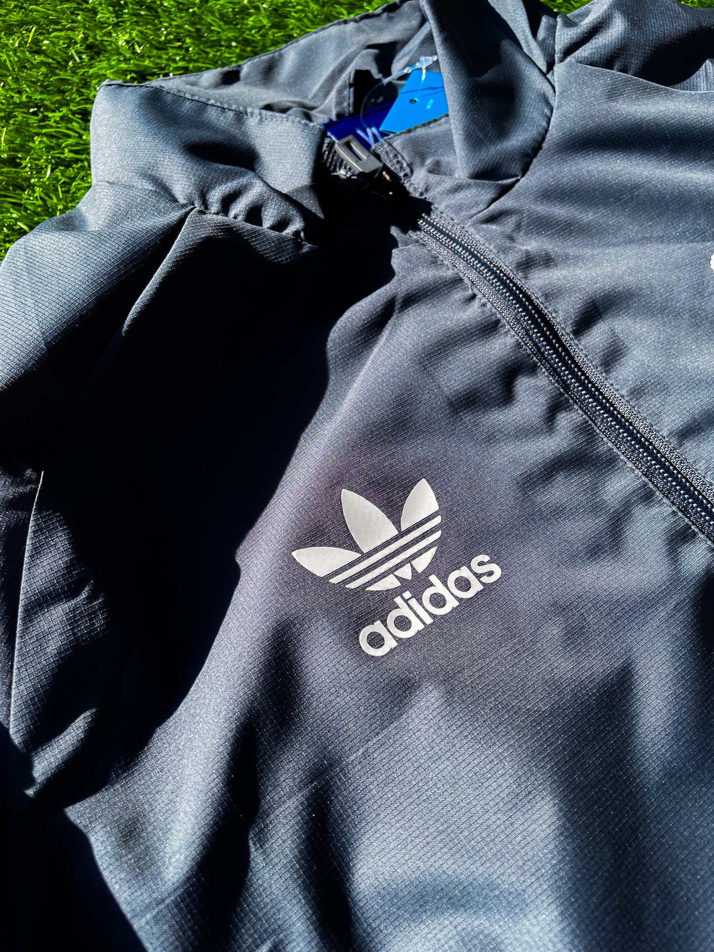 Close-up of embroidered Real Madrid crest and Adidas logo