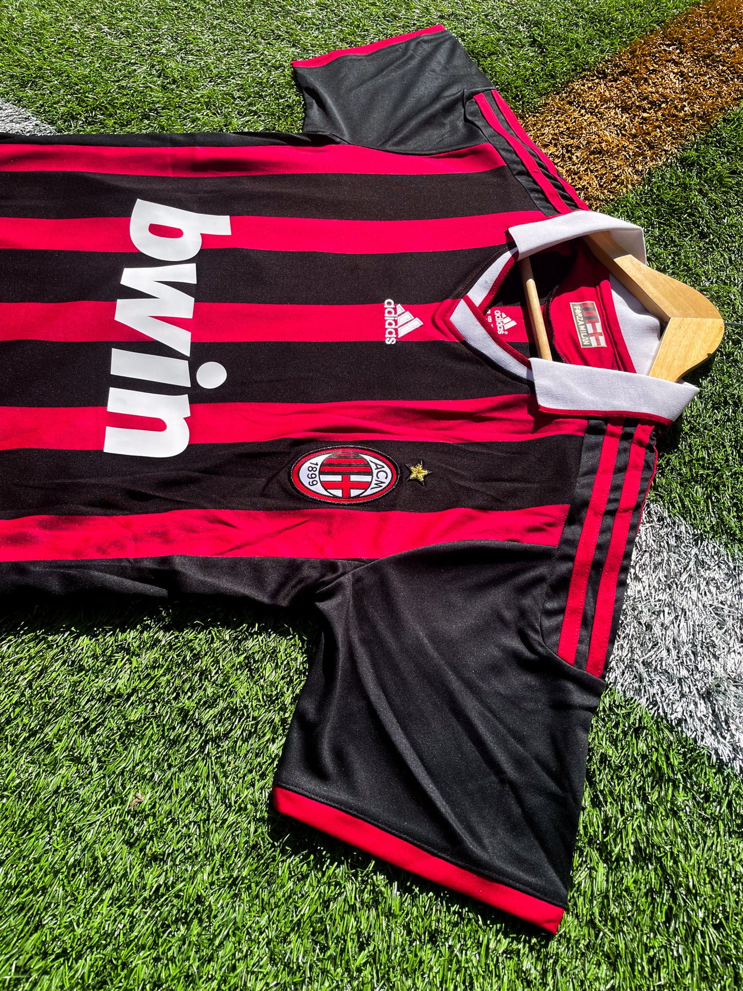 Close-up of Adidas logo and AC Milan crest on the 2009-2010 home jersey