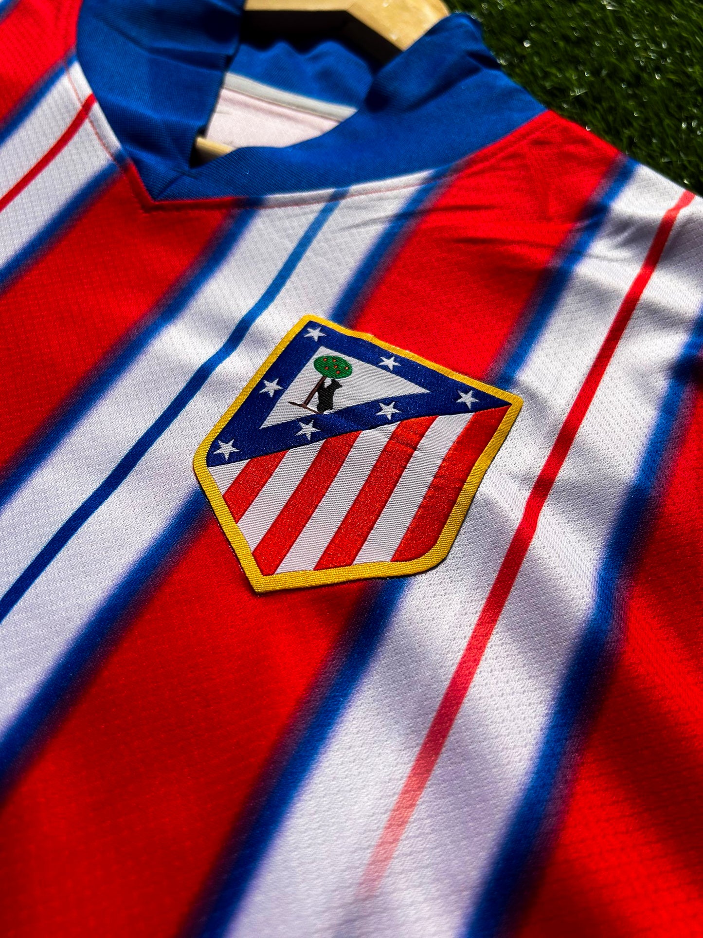 Close-up of Nike logo and Atlético Madrid crest on the 2024-2025 home jersey