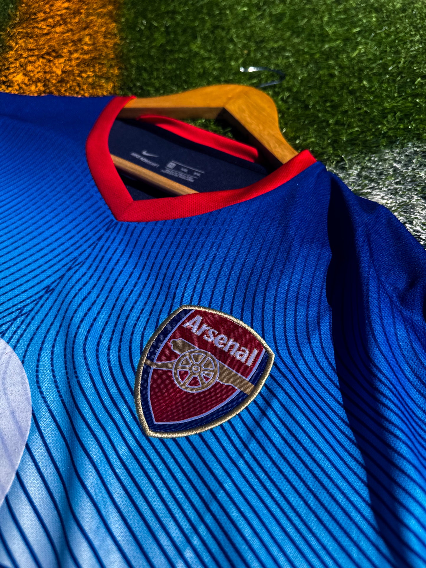 Close-up of crest and yellow detailing on blue Nike design