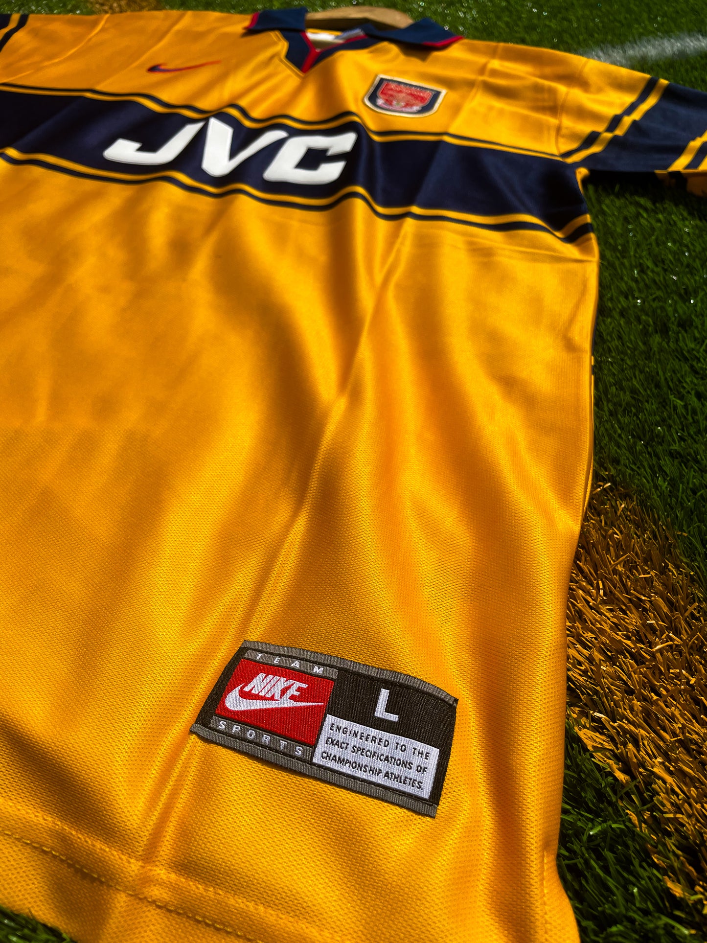 Close-up of Arsenal crest and JVC sponsor logo