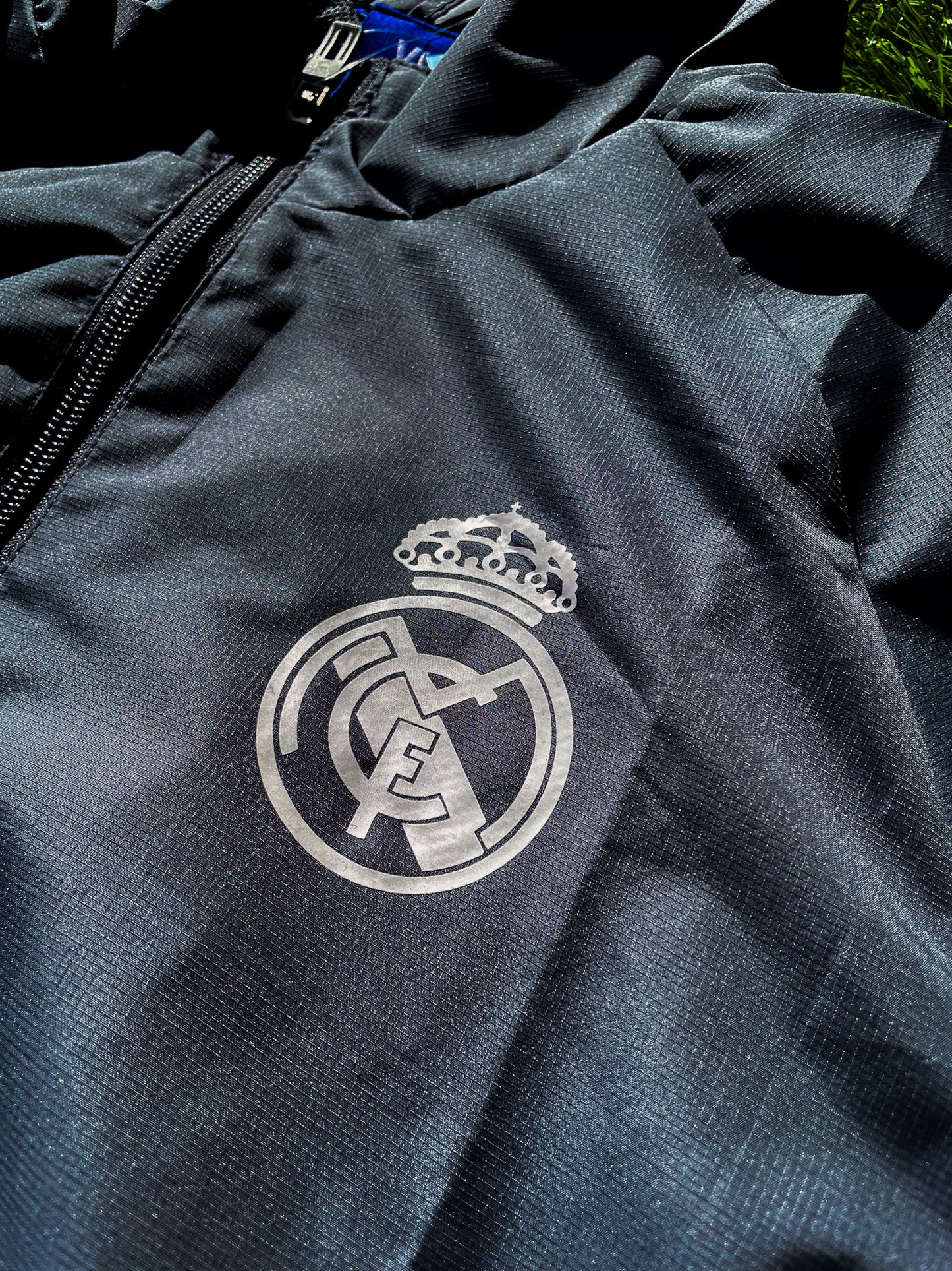 Close-up of embroidered Real Madrid crest and Adidas logo