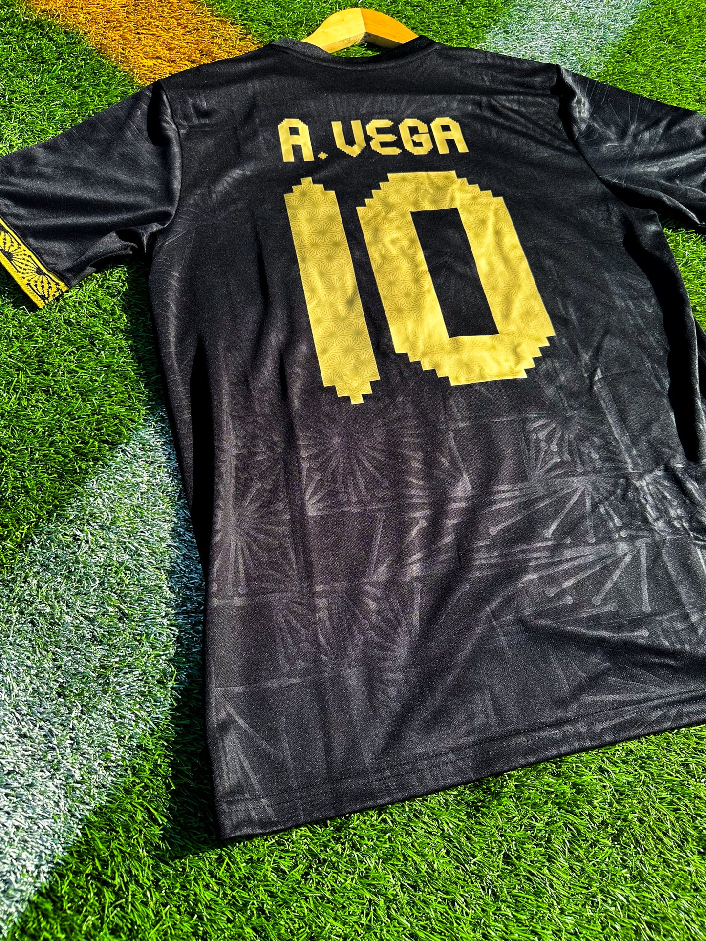 Back view showing A Vega #10 print on black jersey