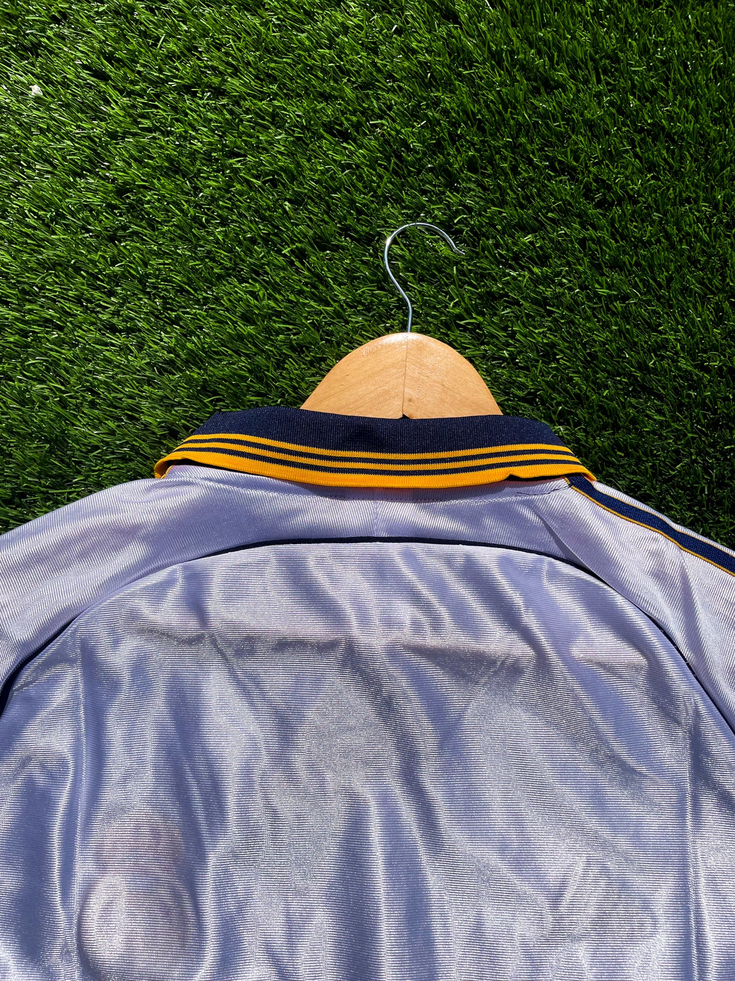 Close-up of embroidered Real Madrid crest and Adidas logo