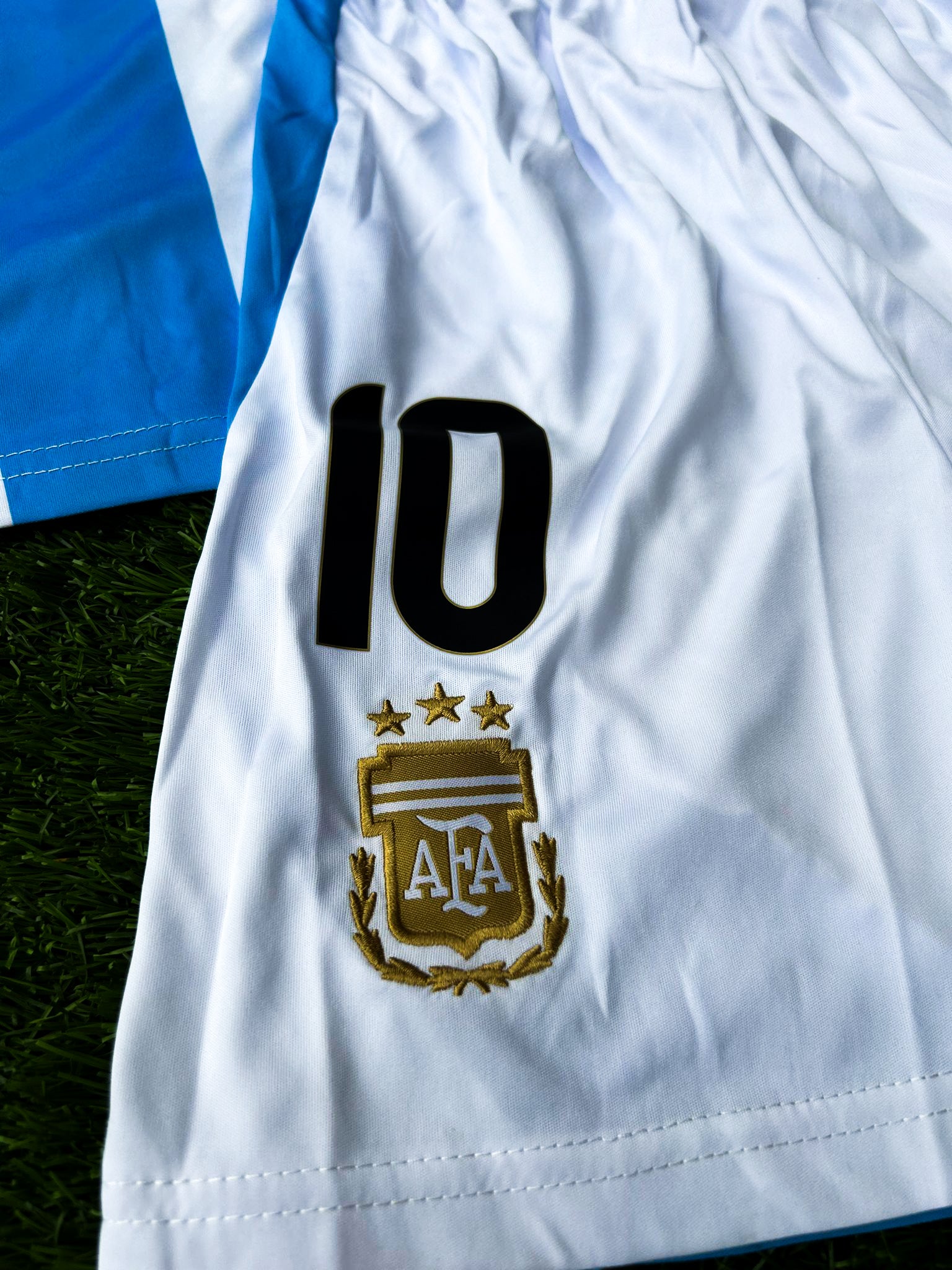 Detail shot of fabric texture and updated 2024 design elements on the kids' shorts. 