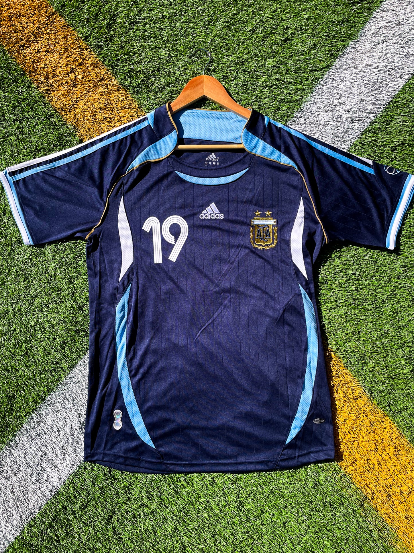 Front view of Argentina 2006 Away Jersey with Messi #19 and AFA crest.