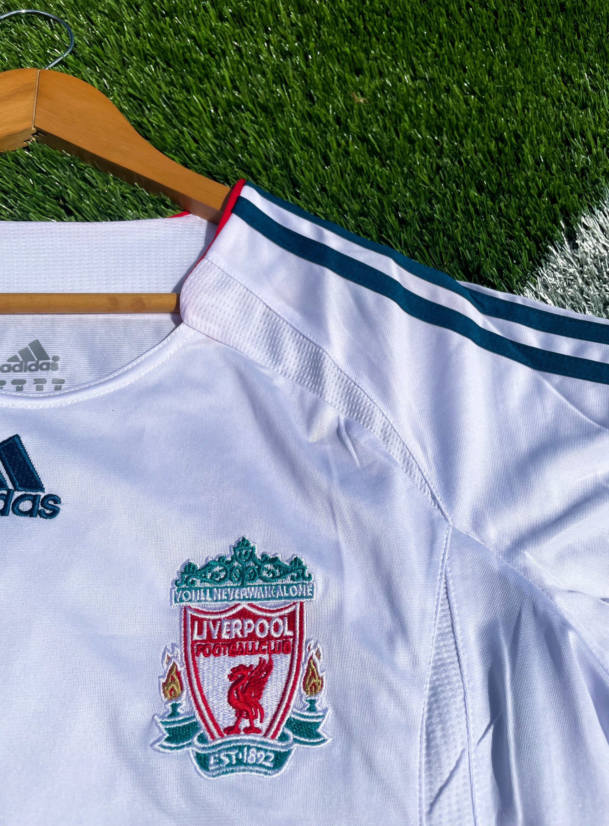 Close-up of club crest, sponsor, and Adidas detailing

