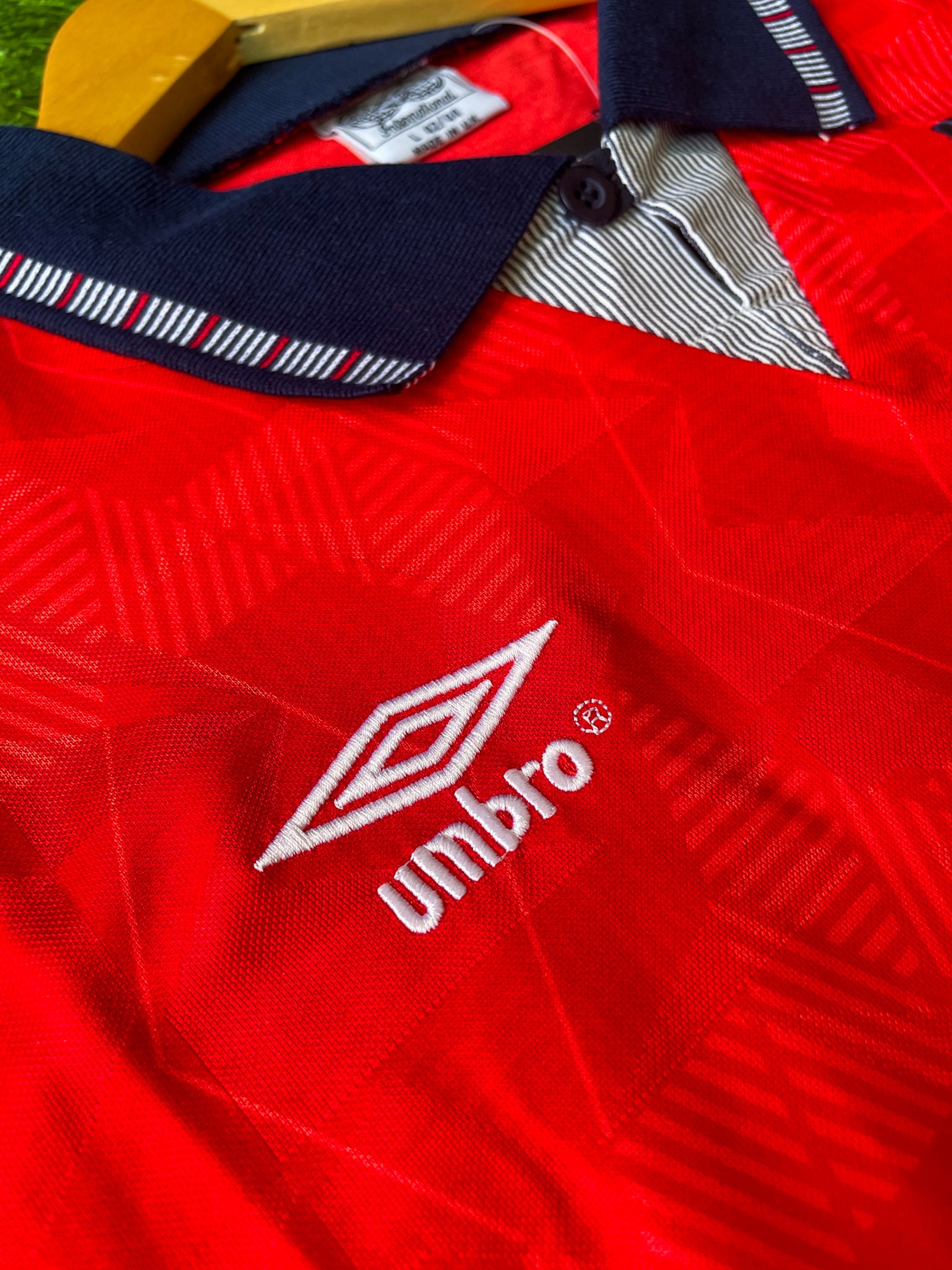 Close-up of Umbro logo and geometric pattern.

