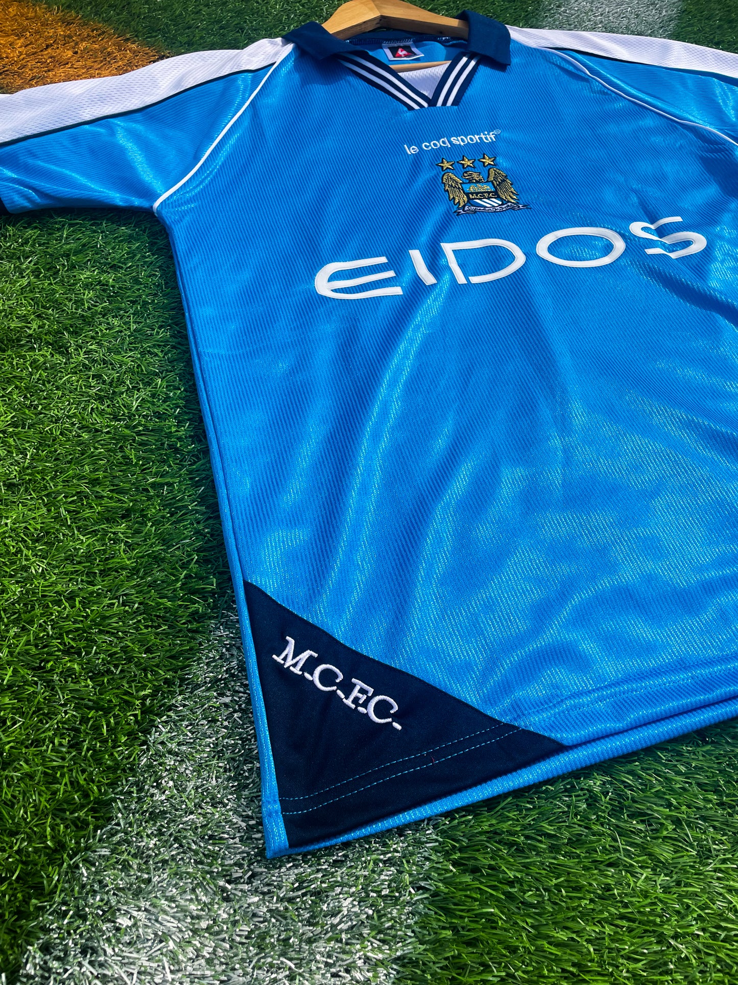 Close-up of sponsor logos and embroidered crest details

